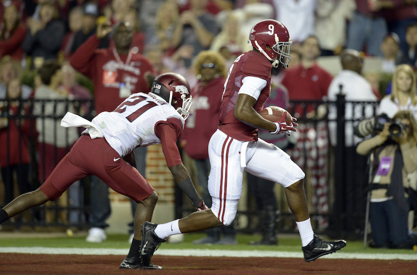 Oct 19, 2013; Tuscaloosa, AL, USA; Alabama Crimson Tide wide receiver Amari Cooper (9) scores a touchdown past Arkansas Razorbacks cornerback Carroll Washington (21) at Bryant-Denny Stadium. Mandatory Credit: John David Mercer-USA TODAY Sports