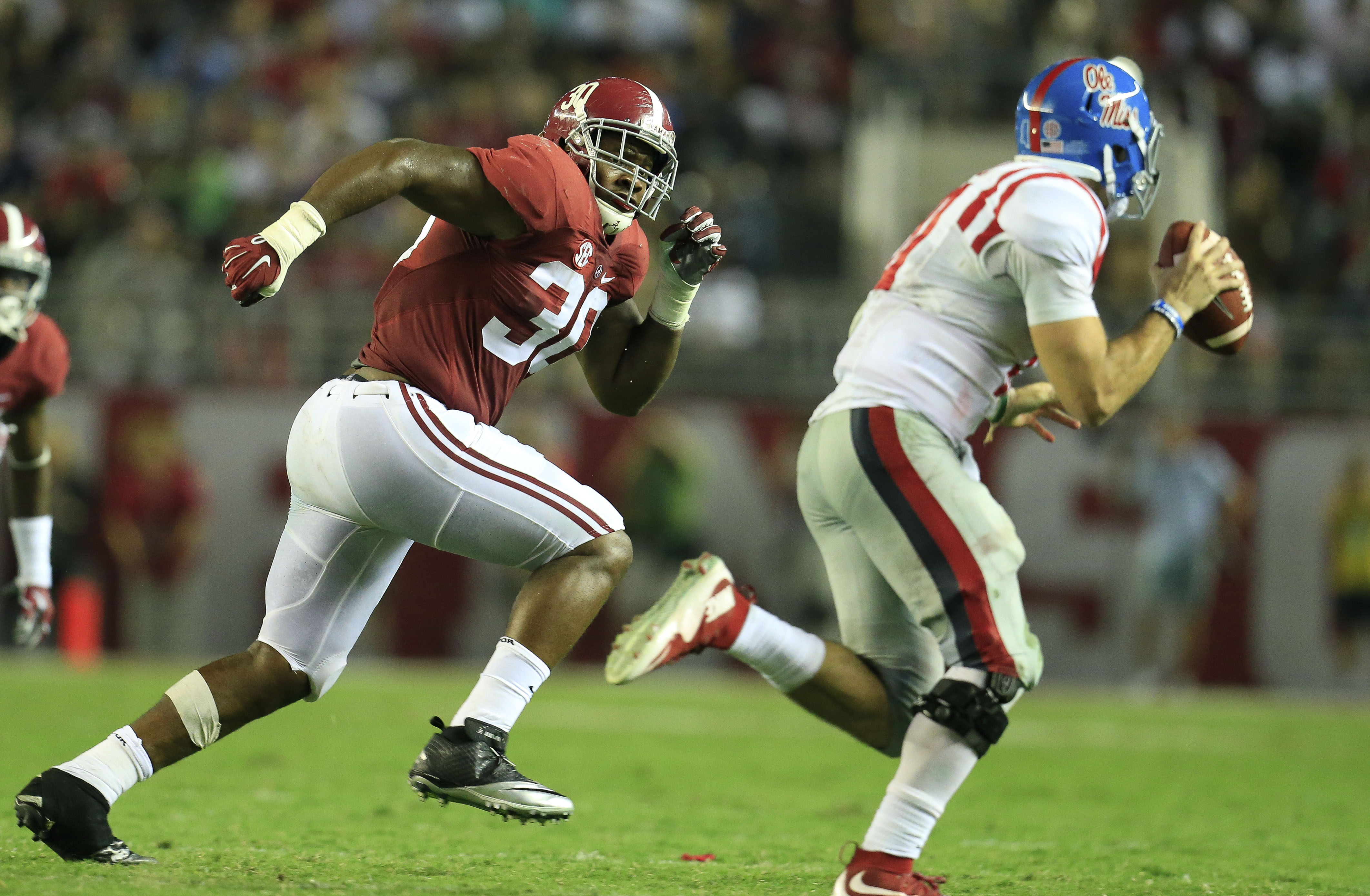 Sep 19, 2015; Tuscaloosa, AL, USA; Alabama Crimson Tide linebacker Denzel Devall (30) chases down Mississippi Rebels quarterback Chad Kelly (10) at Bryant-Denny Stadium. The Rebels defeated the Tide 43-37. Mandatory Credit: Marvin Gentry-USA TODAY Sports