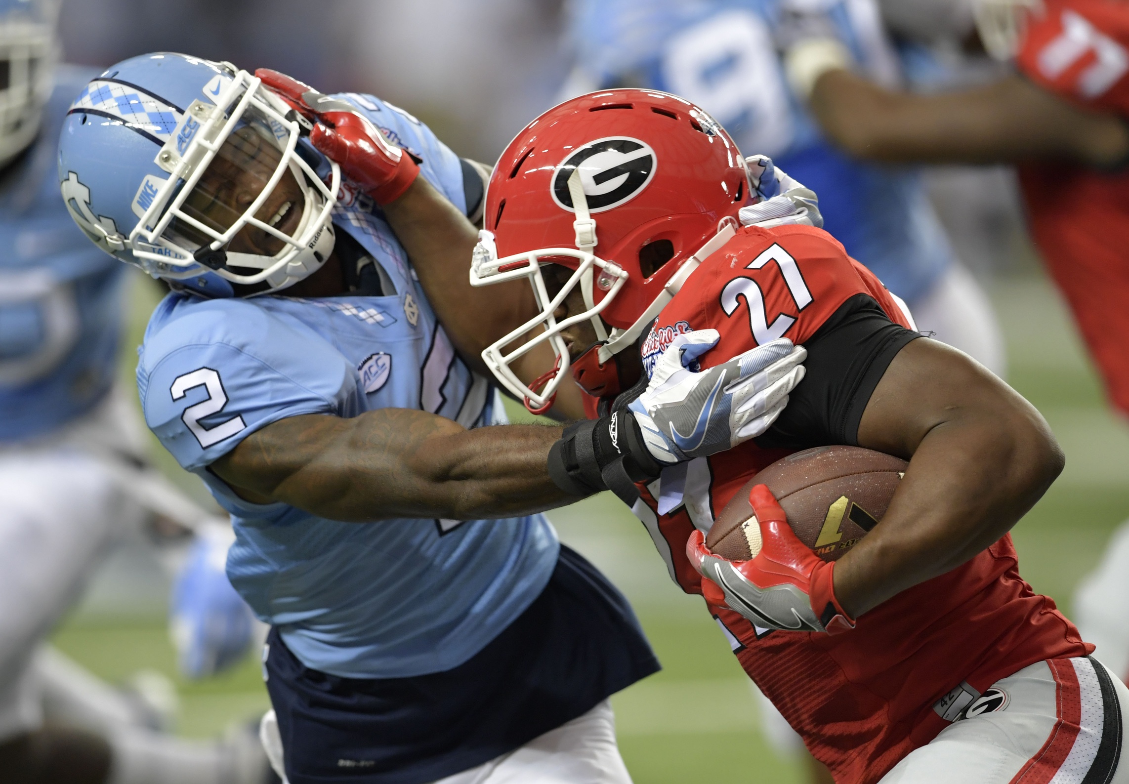 Sep 3, 2016; Atlanta, GA, USA; Georgia Bulldogs running back Nick Chubb (27) runs the ball against North Carolina Tar Heels safety Dominquie Green (26) during the second quarter of the 2016 Chick-Fil-A Kickoff game at Georgia Dome. Mandatory Credit: Brett Davis-USA TODAY Sports