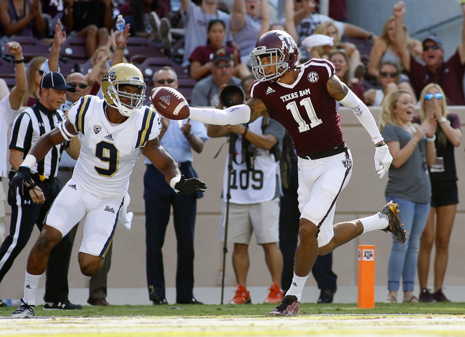 Sep 3, 2016; College Station, TX, USA; Texas A&M Aggies wide receiver Josh Reynolds (11) goes in the for a 40-yard touchdown catch against UCLA Bruins defensive back Marcus Rios (9) during the second half at Kyle Field. Texas A&M won in overtime 31-24. Mandatory Credit: Ray Carlin-USA TODAY Sports