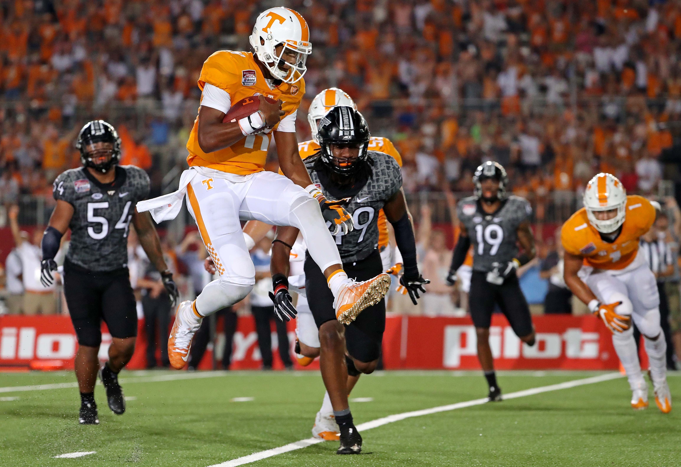 Sep 10, 2016; Bristol, TN, USA; Tennessee Volunteers quarterback Joshua Dobbs (11) scores a touchdown against the Virginia Tech Hokies during the second quarter at Bristol Motor Speedway. Mandatory Credit: Peter Casey-USA TODAY Sports
