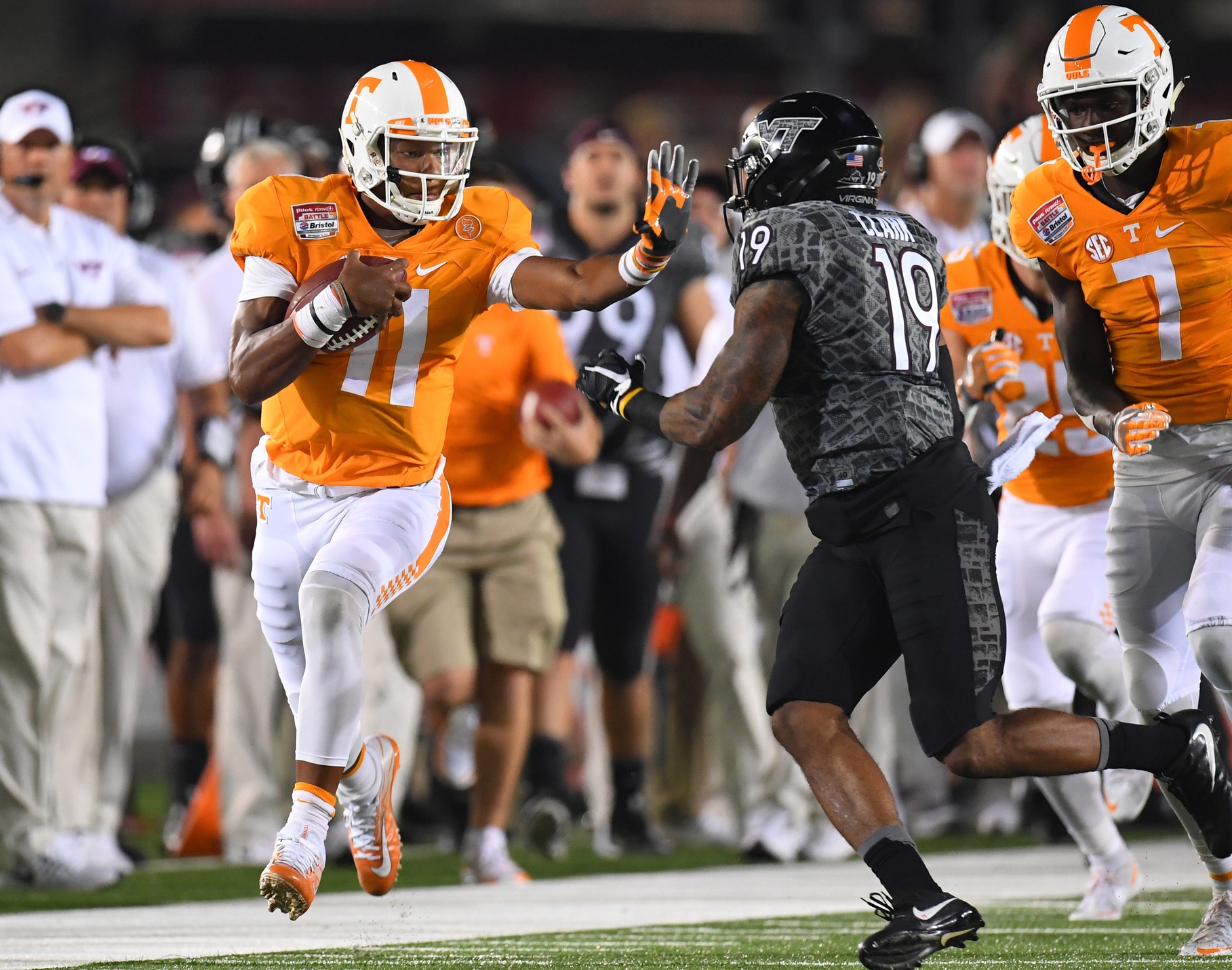Sep 10, 2016; Bristol, TN, USA; Tennessee Volunteers quarterback Joshua Dobbs (11) fights off a tackle attempt by Virginia Tech Hokies defensive back Chuck Clark (19) during the first half at Bristol Motor Speedway. Mandatory Credit: Christopher Hanewinckel-USA TODAY Sports