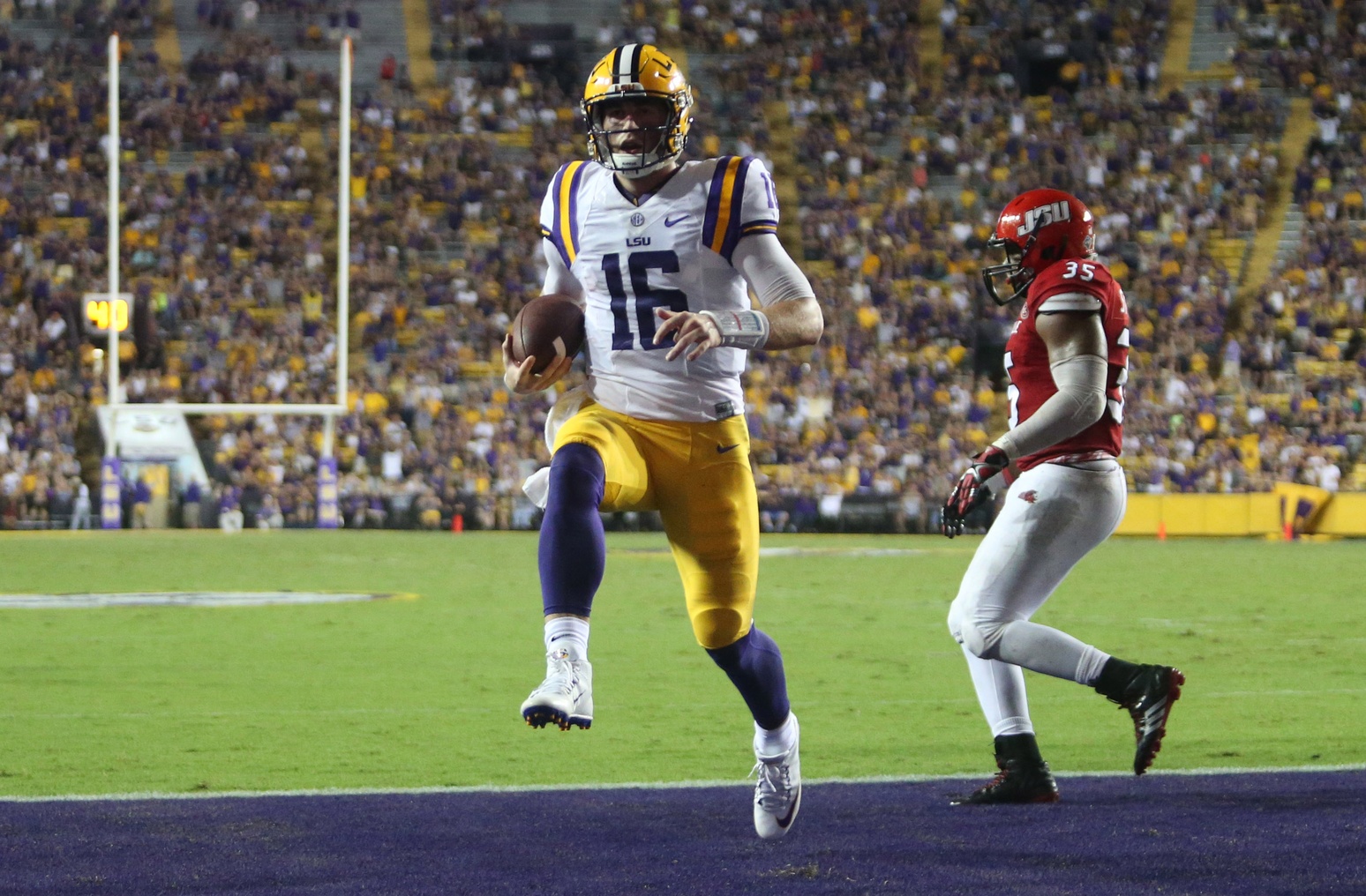 Sep 10, 2016; Baton Rouge, LA, USA; LSU Tigers quarterback Danny Etling (16) runs the ball into the end zone for a touchdown in front of Jacksonville State Gamecocks linebacker Quan Stoudemire (35) during the second half at Tiger Stadium. LSU defeated Jacksonville State 34-13. Mandatory Credit: Crystal LoGiudice-USA TODAY Sports