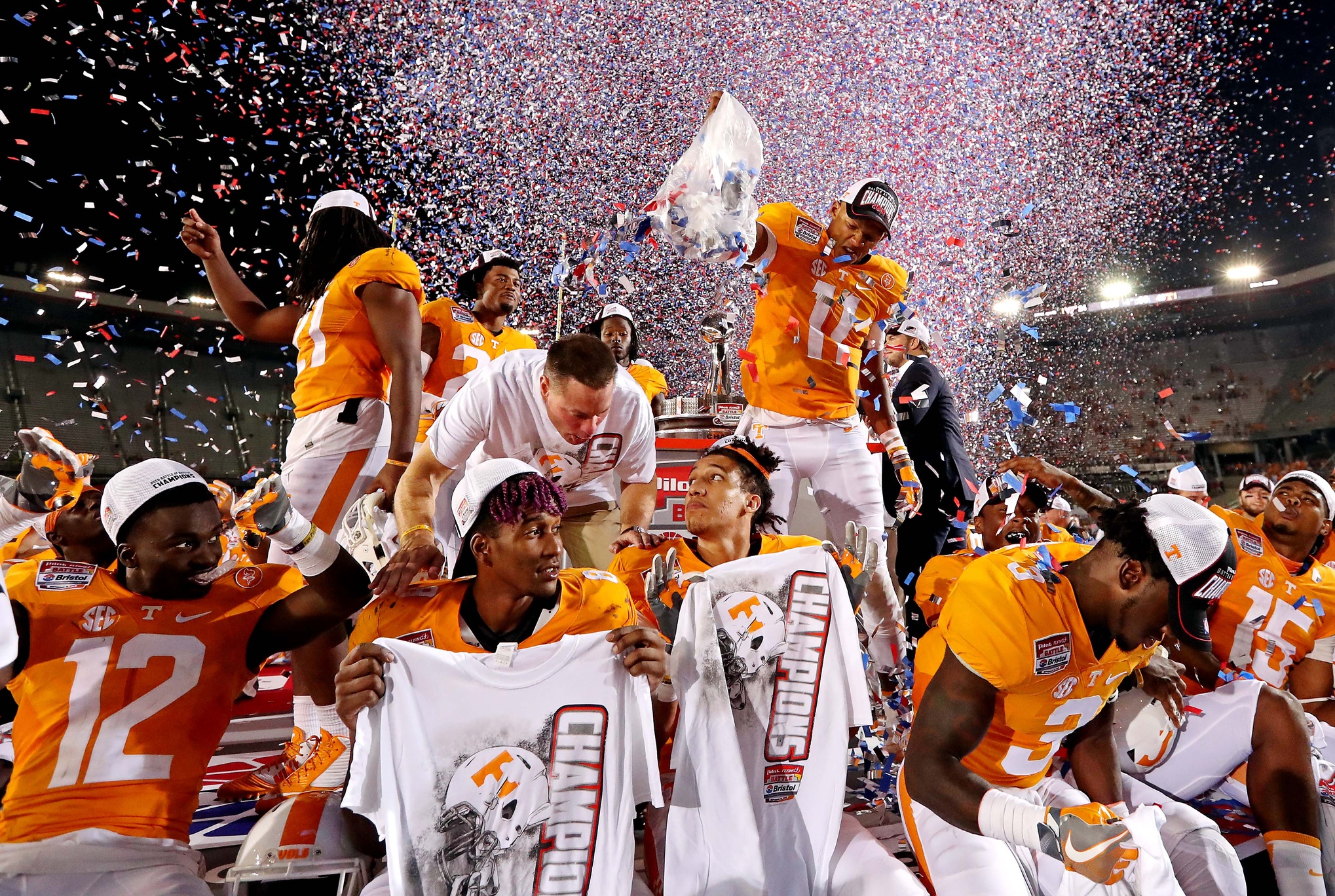 Sep 10, 2016; Bristol, TN, USA; Tennessee Volunteers quarterback Joshua Dobbs (11) dumbs confetti on his teammates after beating the Virginia Tech Hokies at Bristol Motor Speedway. Mandatory Credit: Peter Casey-USA TODAY Sports