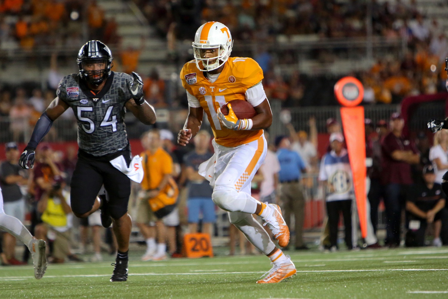 Sep 10, 2016; Bristol, TN, USA; Tennessee Volunteers quarterback Joshua Dobbs (11) runs the ball against the Virginia Tech Hokies during the second half at Bristol Motor Speedway. Tennessee won 45 to 24. Mandatory Credit: Randy Sartin-USA TODAY Sports