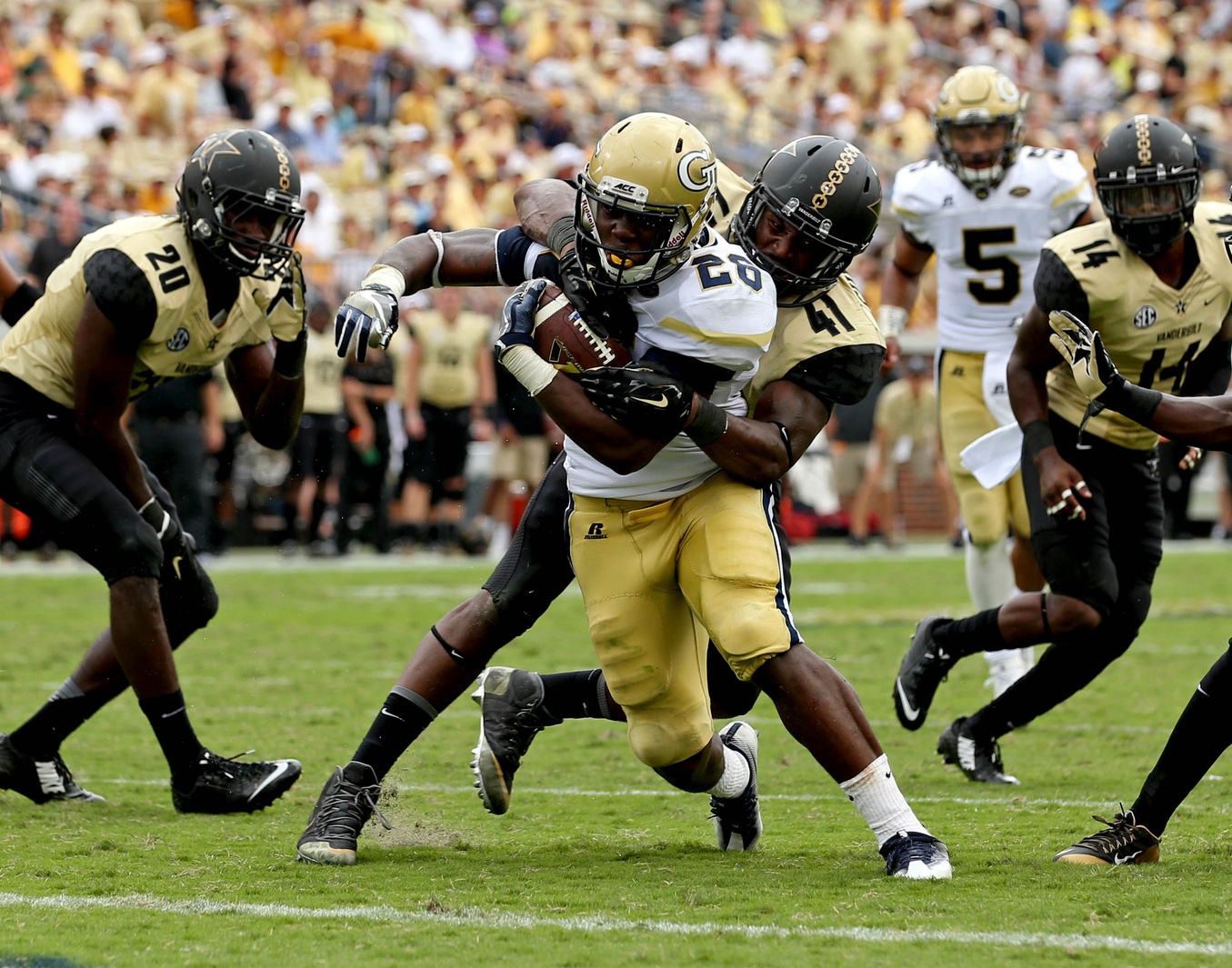 Sep 17, 2016; Atlanta, GA, USA; Georgia Tech Yellow Jackets running back Dedrick Mills (26) scores a rushing touchdown against Vanderbilt Commodores linebacker Zach Cunningham (41) in the third quarter of their game at Bobby Dodd Stadium. The Yellow Jackets won 38-7. Mandatory Credit: Jason Getz-USA TODAY Sports