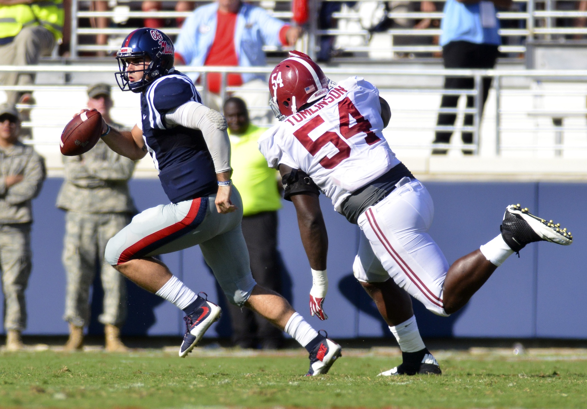 Sep 17, 2016; Oxford, MS, USA; Mississippi Rebels quarterback Chad Kelly (10) attempts to avoid Alabama Crimson Tide defensive lineman Dalvin Tomlinson (54) during the second quarter of the game at Vaught-Hemingway Stadium. Mandatory Credit: Matt Bush-USA TODAY Sports