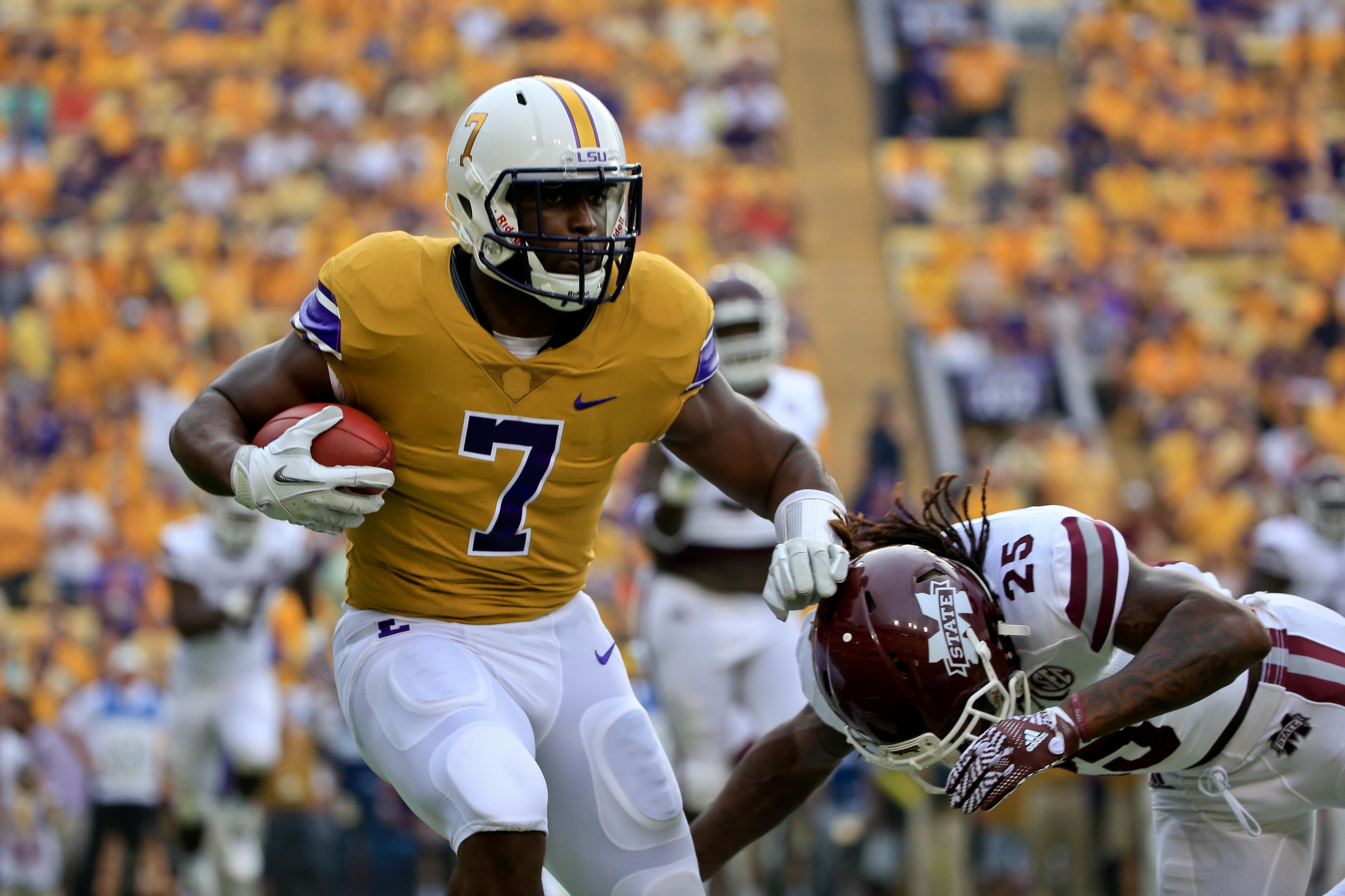 Sep 17, 2016; Baton Rouge, LA, USA; LSU Tigers running back Leonard Fournette (7) is defended by Mississippi State Bulldogs defensive back Lashard Durr (25) during the first quarter of a game at Tiger Stadium. Mandatory Credit: Derick E. Hingle-USA TODAY Sports