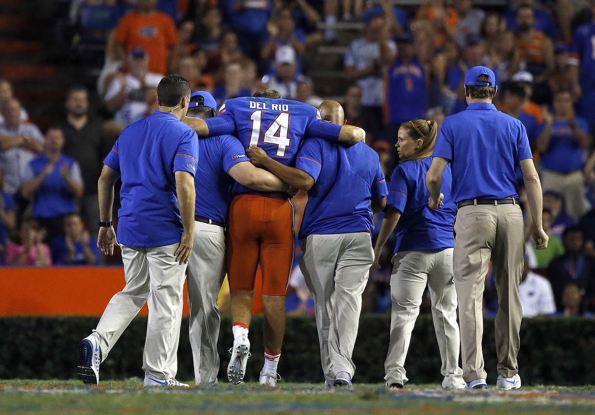 Sep 17, 2016; Gainesville, FL, USA; Florida Gators quarterback Luke Del Rio (14) gets helped off the field after an apparent injury during the second half against the North Texas Mean Green at Ben Hill Griffin Stadium. Florida Gators defeated the North Texas Mean Green 32-0. Mandatory Credit: Kim Klement-USA TODAY Sports