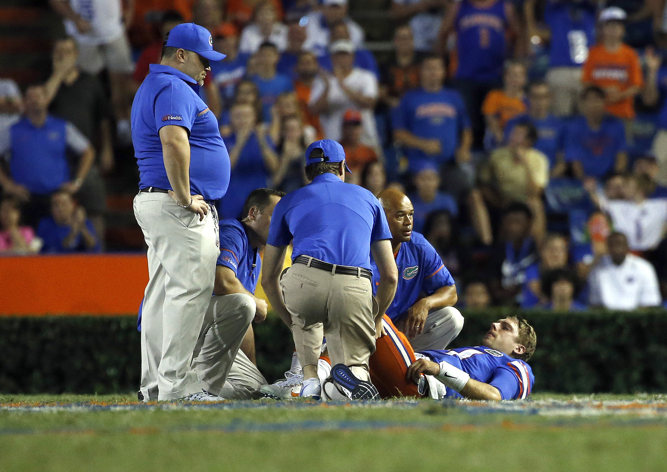 Sep 17, 2016; Gainesville, FL, USA; Florida Gators quarterback Luke Del Rio (14) gets checked out by trainers on the field and then leaves the game against the North Texas Mean Green during the second half at Ben Hill Griffin Stadium. Florida Gators defeated the North Texas Mean Green 32-0. Mandatory Credit: Kim Klement-USA TODAY Sports