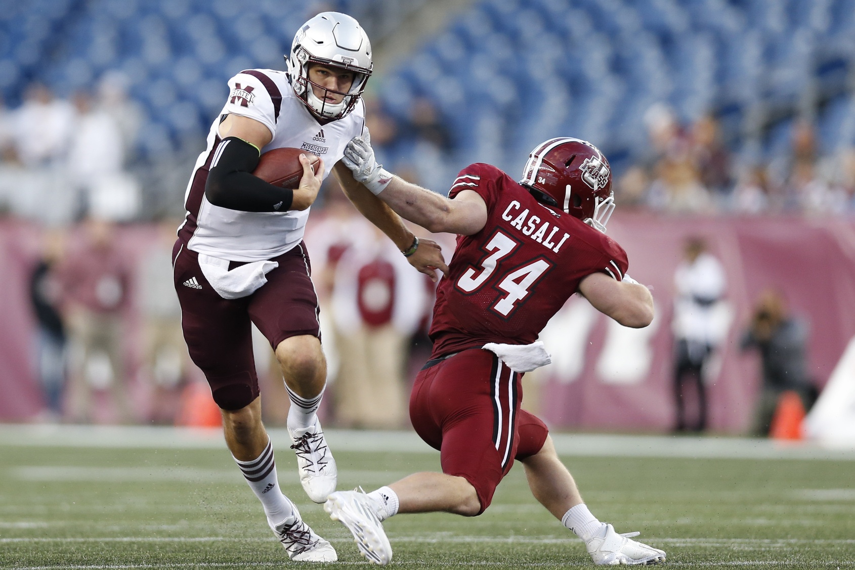 Sep 24, 2016; Foxborough, MA, USA; Mississippi State Bulldogs quarterback Nick Fitzgerald (7) evades a tackle by Massachusetts Minutemen line backer Steve Casali (34) during the third quarter at Gillette Stadium. Mississippi State won 47-35. Credit: Greg M. Cooper-USA TODAY Sports