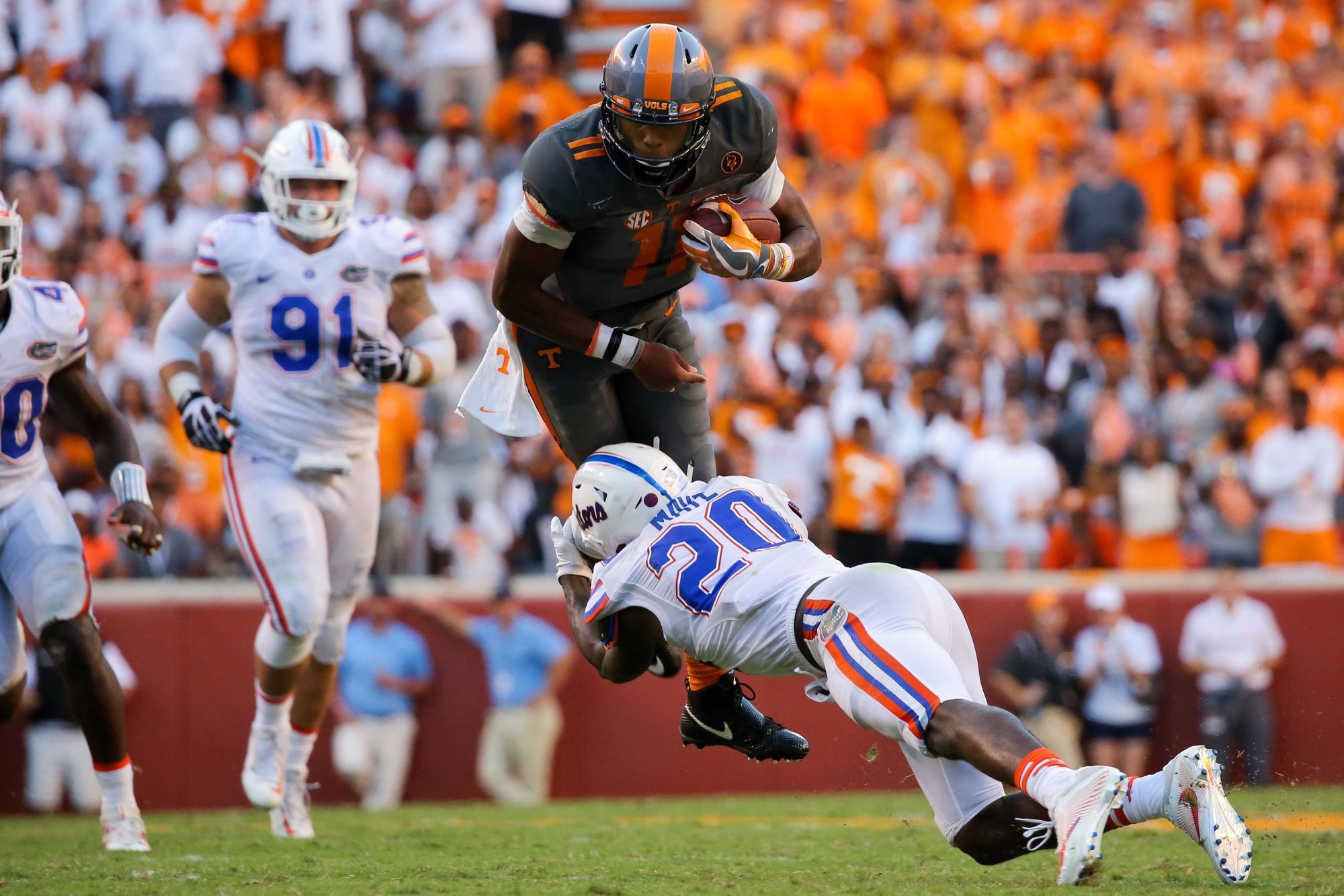 Sep 24, 2016; Knoxville, TN, USA; Tennessee Volunteers quarterback Joshua Dobbs (11) runs the ball against Florida Gators defensive back Marcus Maye (20) during the second half at Neyland Stadium. Tennessee won 38-28. Mandatory Credit: Randy Sartin-USA TODAY Sports