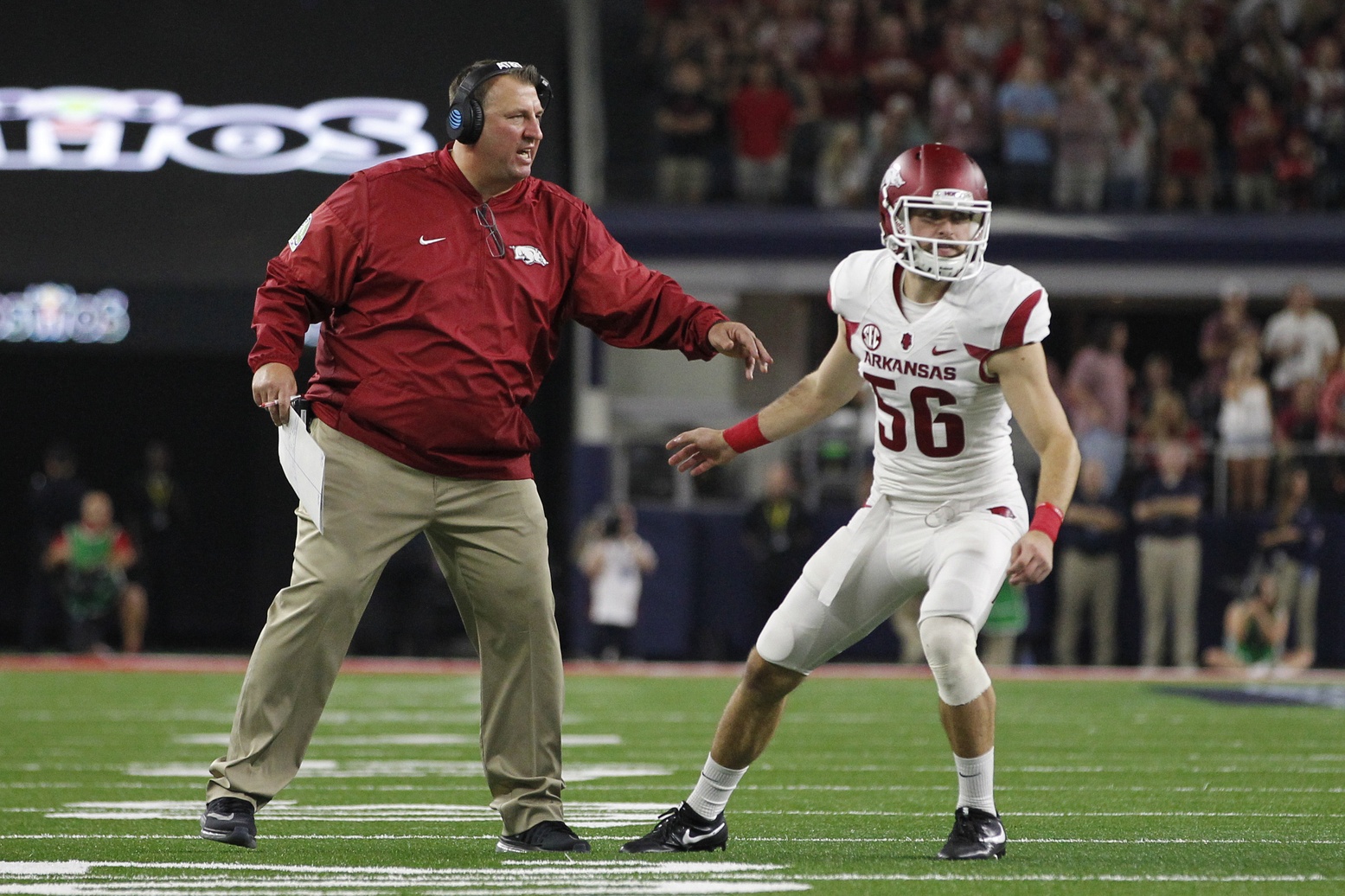 Sep 24, 2016; Dallas, TX, USA; Arkansas Razorbacks head coach Bret Bielema talks to Razorbacks long snapper Matt Emrich (56) before a field goal attempt in the second quarter against the Texas A&M Aggies at AT&T Stadium. Mandatory Credit: Tim Heitman-USA TODAY Sports