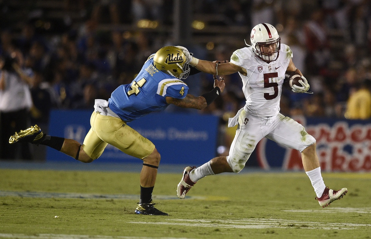 Sep 24, 2016; Pasadena, CA, USA; Stanford Cardinal running back Christian McCaffrey (5) runs the ball past UCLA Bruins linebacker Cameron Judge (4) during the second half at Rose Bowl. The Stanford Cardinal won 22-13. Mandatory Credit: Kelvin Kuo-USA TODAY Sports