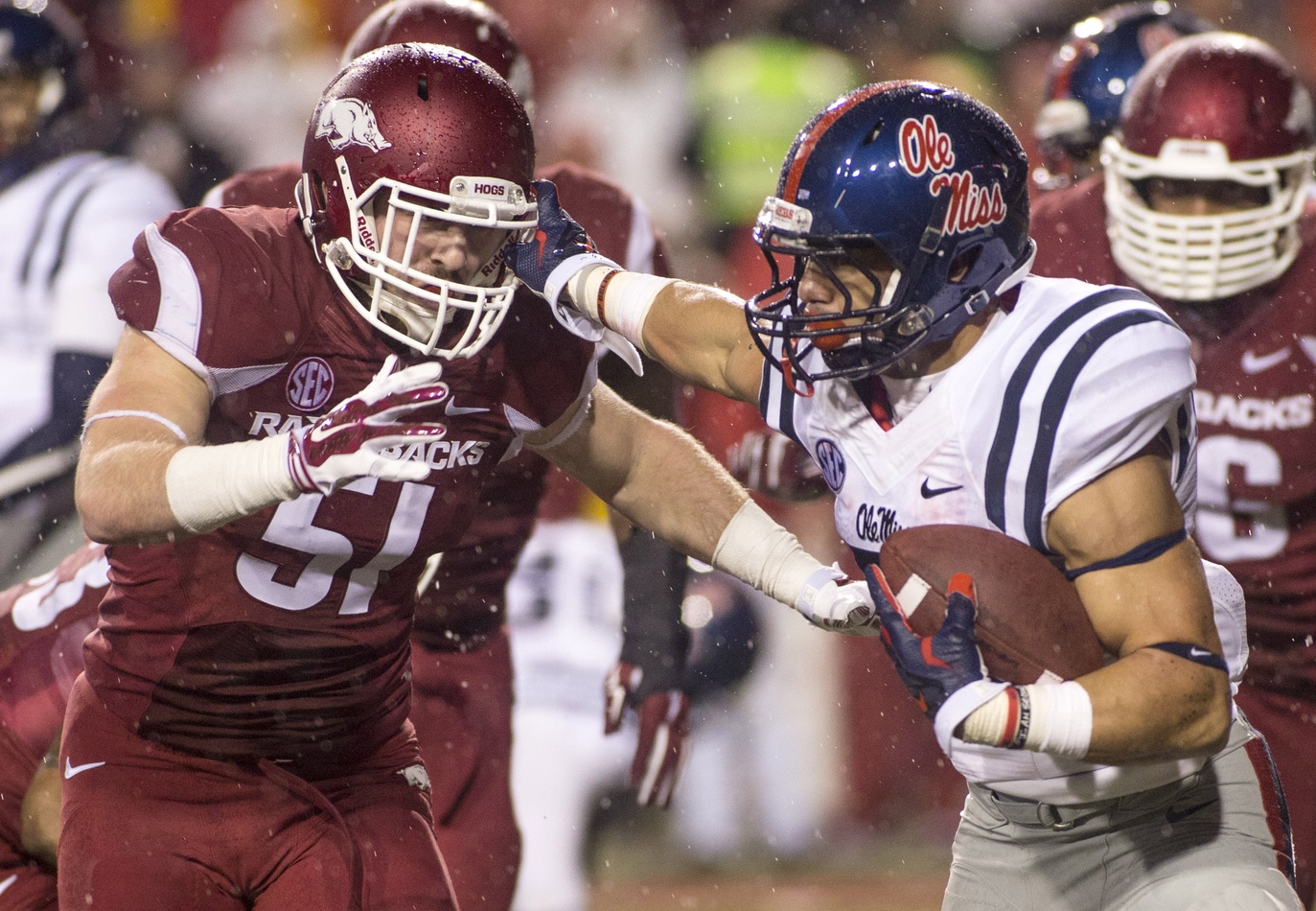 Nov 22, 2014; Fayetteville, AR, USA; Ole Miss Rebels running back Jordan Wilknis (22) carries the ball as Arkansas Razorbacks linebacker Brooks Ellis (51) defends at Donald W. Reynolds Razorback Stadium. The Razorbacks won 30-0. Mandatory Credit: Beth Hall-USA TODAY Sports