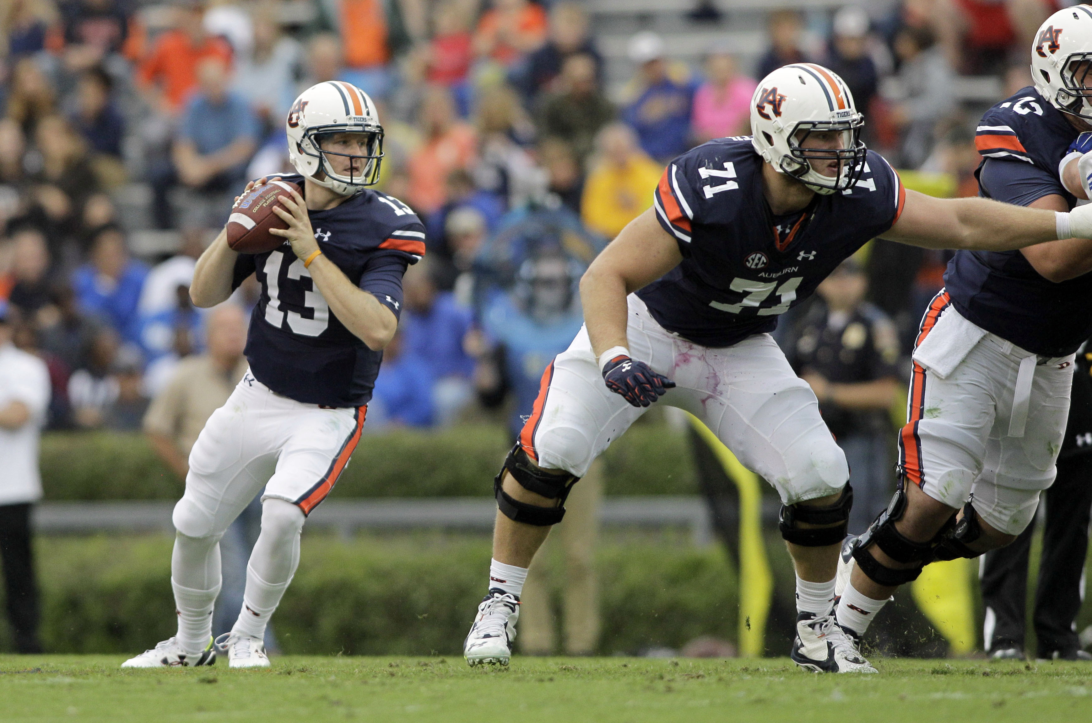 Oct 3, 2015; Auburn, AL, USA; Auburn Tigers quarterback Sean White (13) drops back to pass as lineman Braden Smith (71) blocks against the San Jose State Spartans during the second quarter at Jordan Hare Stadium. Mandatory Credit: John Reed-USA TODAY Sports