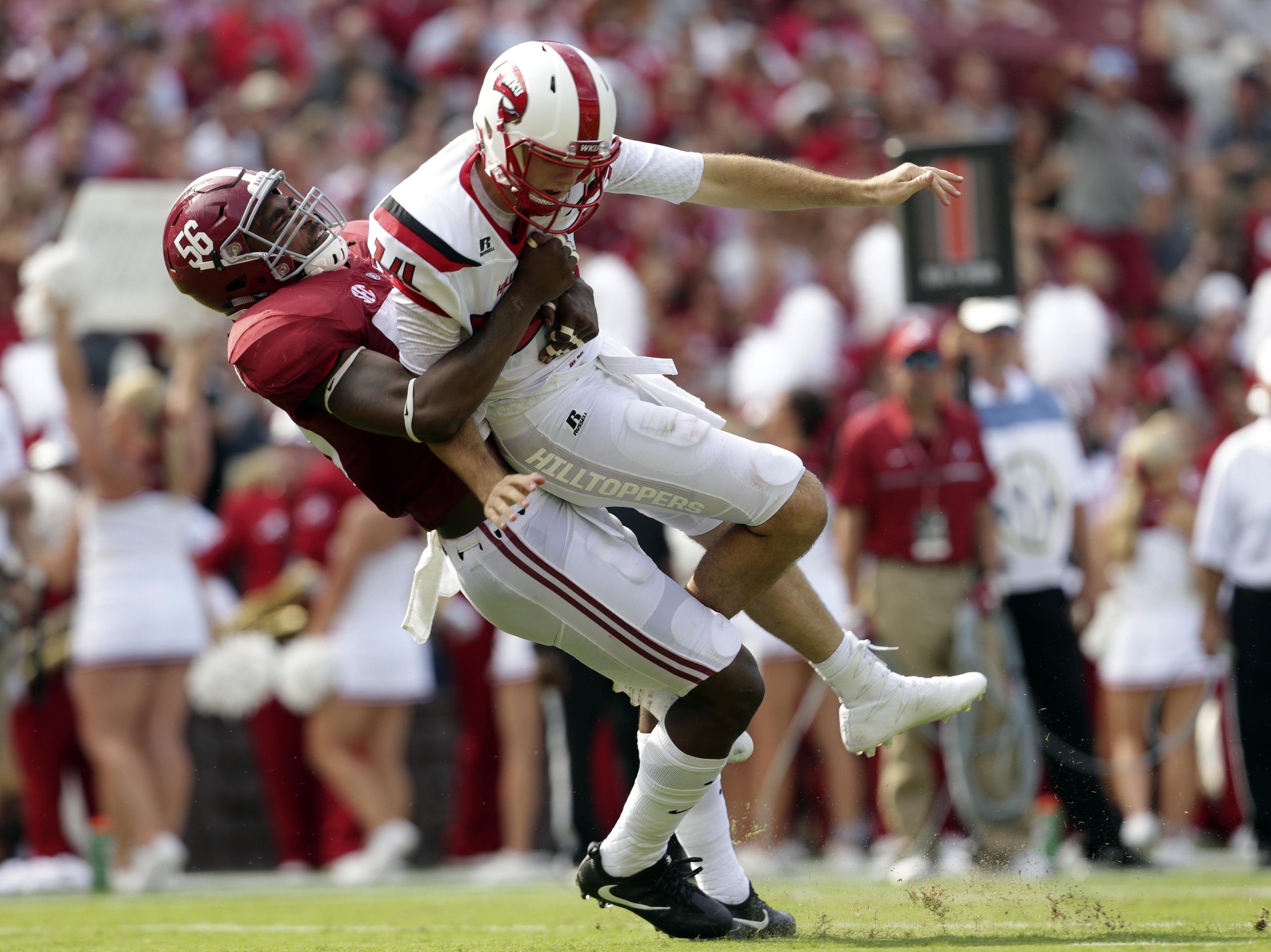 Sep 10, 2016; Tuscaloosa, AL, USA; Alabama Crimson Tide linebacker Tim Williams (56) throws Western Kentucky Hilltoppers quarterback Mike White (14) to the ground and receives a roughing the passer call for the play at Bryant-Denny Stadium. Mandatory Credit: Marvin Gentry-USA TODAY Sports