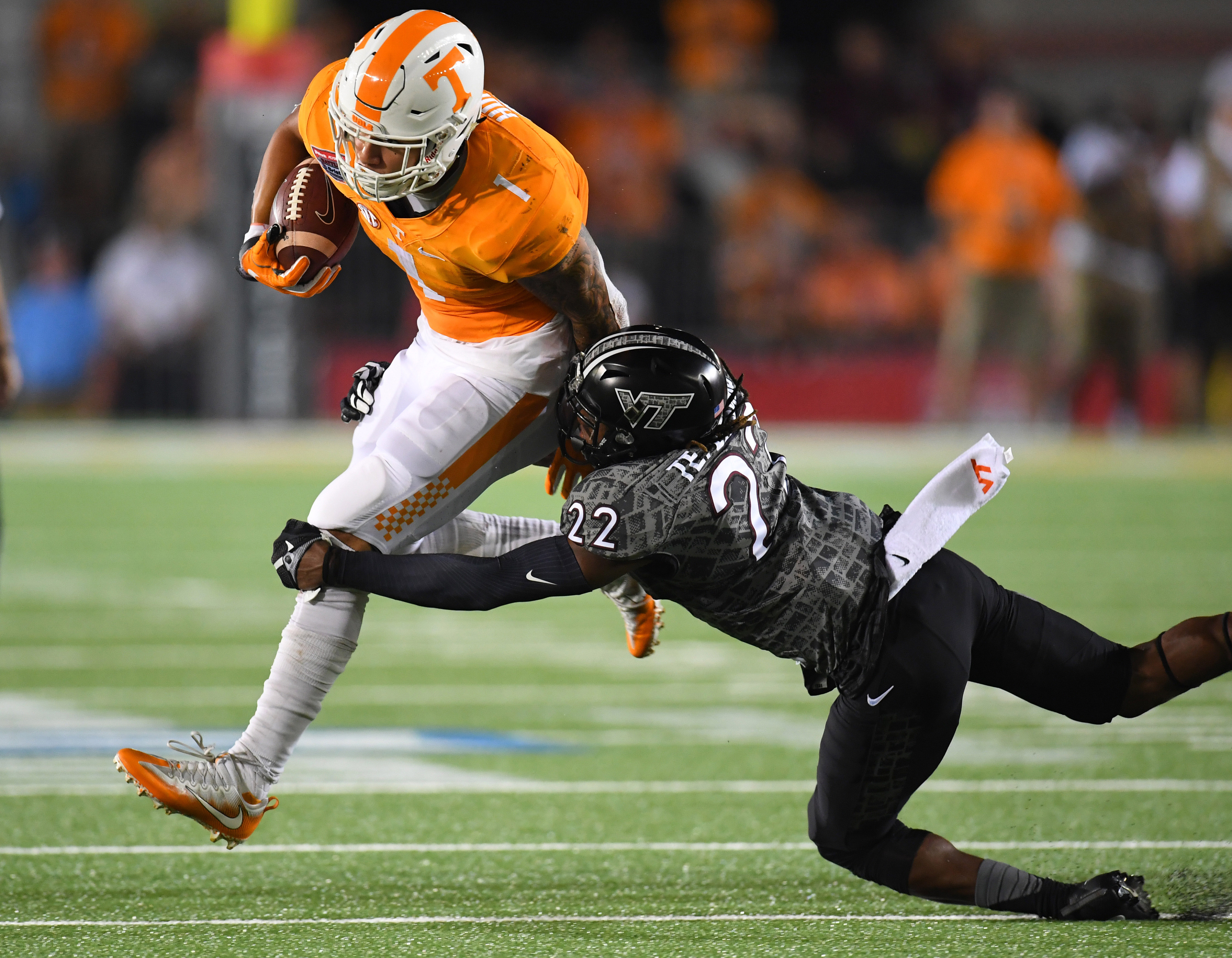 Sep 10, 2016; Bristol, TN, USA; Tennessee Volunteers running back Jalen Hurd (1) runs for a short gain while being tackled by Virginia Tech Hokies defensive back Terrell Edmunds (22) during the first half at Bristol Motor Speedway. Mandatory Credit: Christopher Hanewinckel-USA TODAY Sports