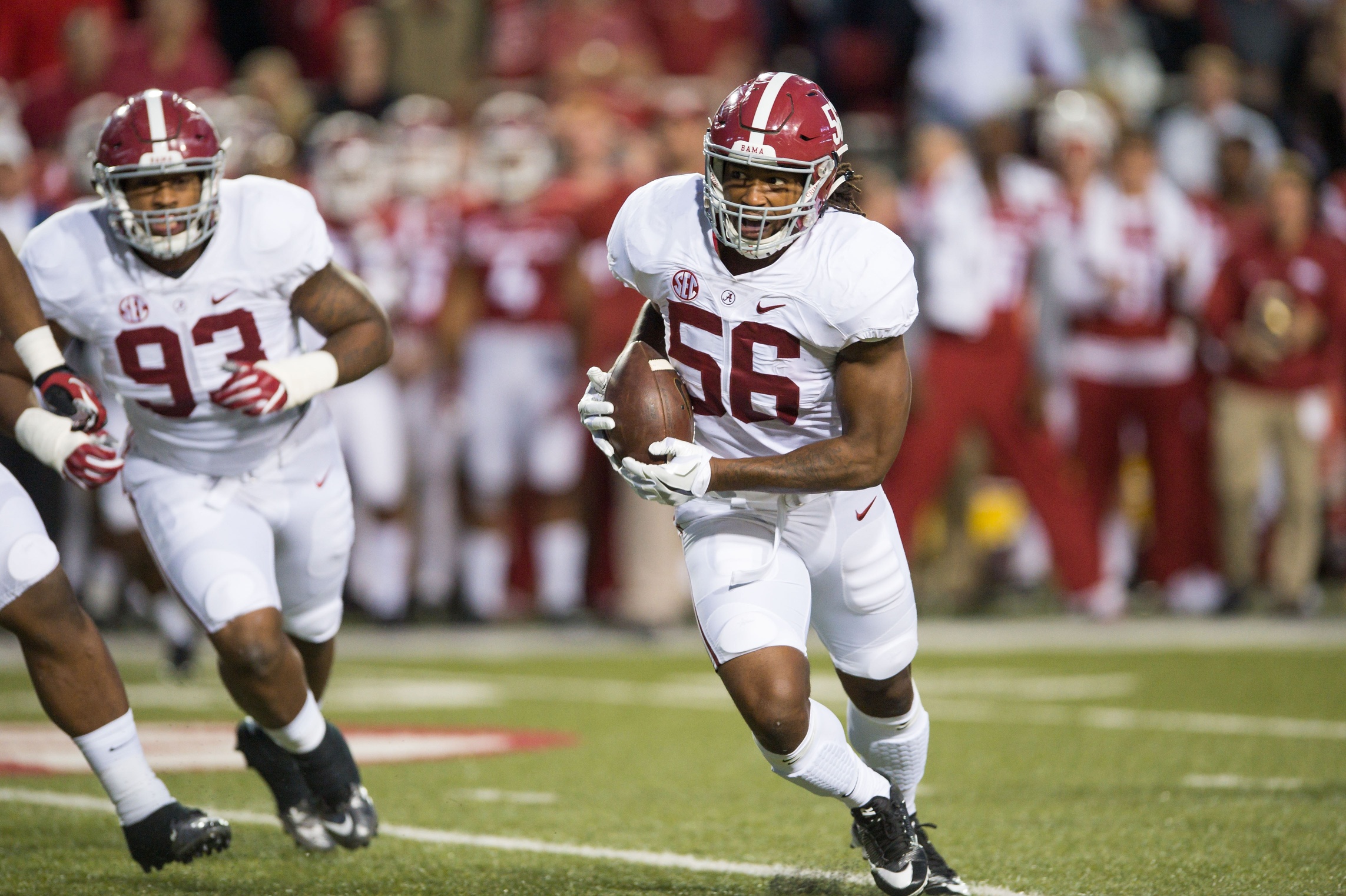 Oct 8, 2016; Fayetteville, AR, USA; Alabama Crimson Tide linebacker Tim Williams (56) returns a fumble by Arkansas Razorbacks quarterback Austin Allen (not pictured) for a touchdown as defensive lineman Jonathan Allen (93) trails the play during the second quarter at Donald W. Reynolds Razorback Stadium. Mandatory Credit: Brett Rojo-USA TODAY Sports