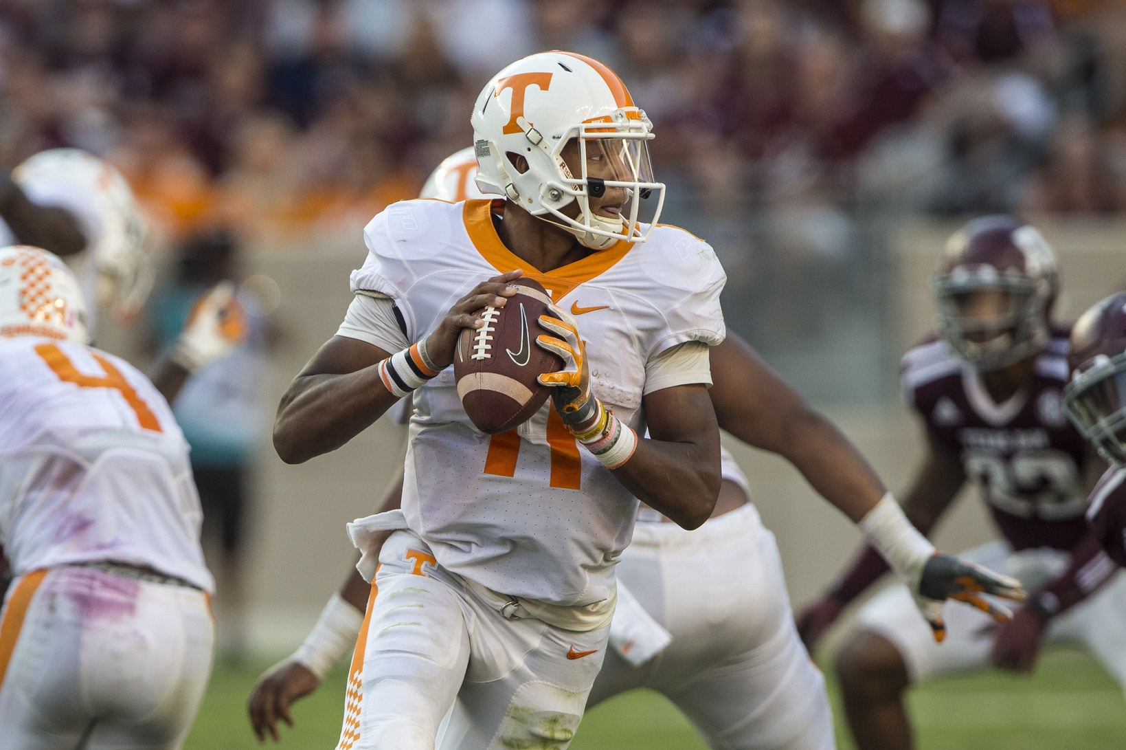 Oct 8, 2016; College Station, TX, USA; Tennessee Volunteers quarterback Joshua Dobbs (11) rolls out to pass against the Texas A&M Aggies during the second half at Kyle Field. The Aggies defeated the Volunteers 45-38 in overtime. Mandatory Credit: Jerome Miron-USA TODAY Sports