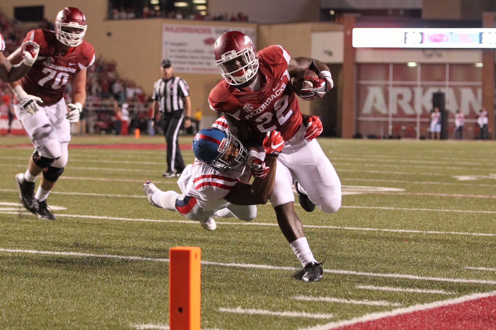 Oct 15, 2016; Fayetteville, AR, USA; Arkansas Razorbacks running back Rawleigh Williams III (22) rushes in the third quarter as Ole Miss Rebels linebacker Terry Caldwell (21) makes a tackle at Donald W. Reynolds Razorback Stadium. Arkansas defeated Ole Miss 34-30. Mandatory Credit: Nelson Chenault-USA TODAY Sports