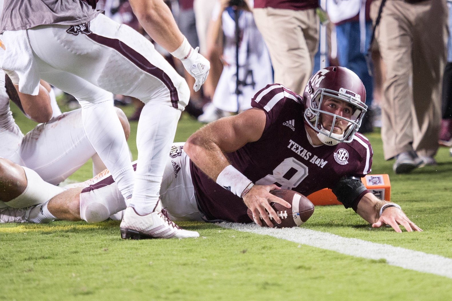 Oct 8, 2016; College Station, TX, USA; Texas A&M Aggies quarterback Trevor Knight (8) scores the winning touchdown against the Tennessee Volunteers during the game at Kyle Field. The Aggies defeat the Volunteers 45-38 in overtime. Mandatory Credit: Jerome Miron-USA TODAY Sports