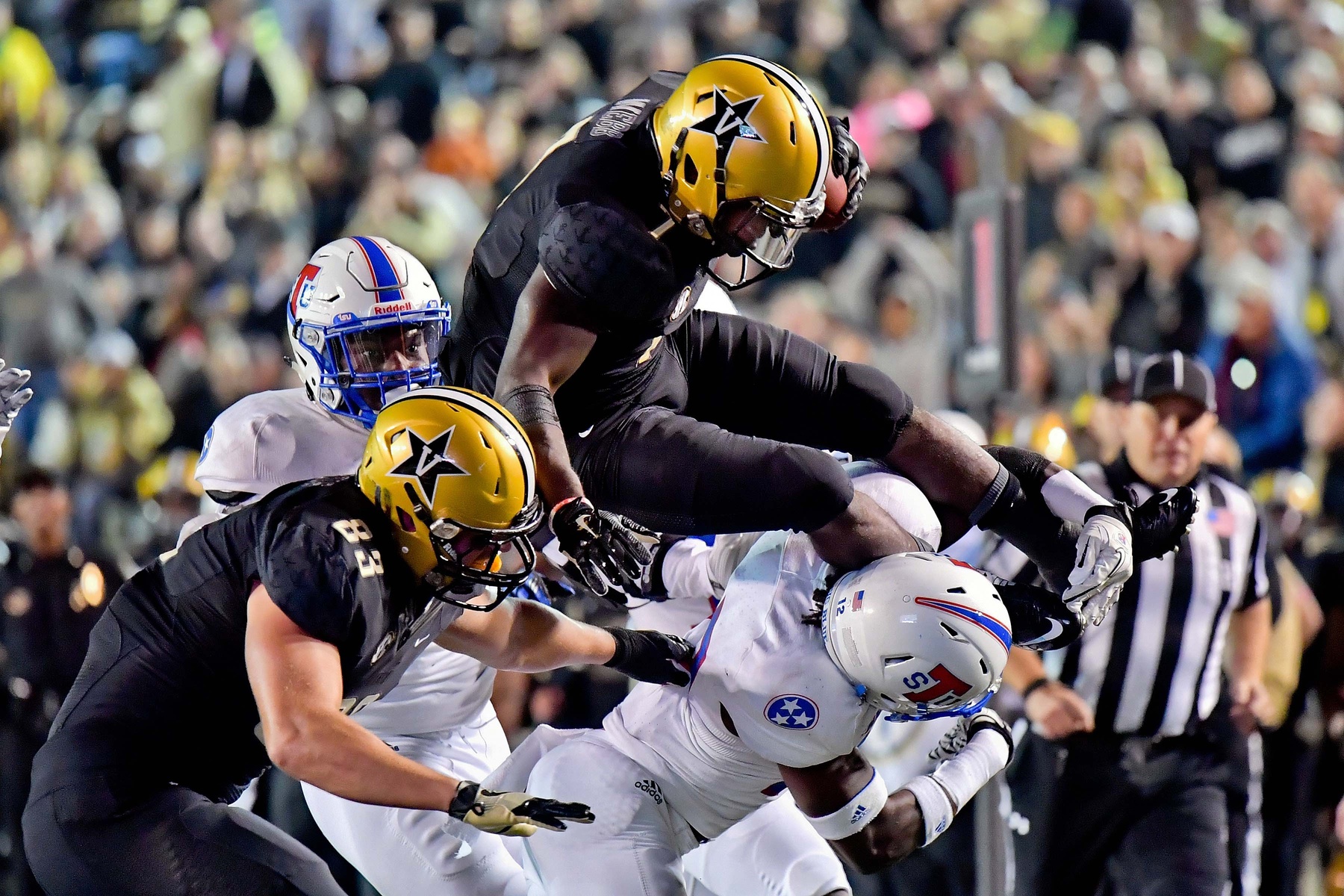 Oct 22, 2016; Nashville, TN, USA; Vanderbilt Commodores running back Ralph Webb (7) leaps to avoid the tackle by Tennessee State Tigers safety Larry Wilhoite (12) during the first half at Vanderbilt Stadium. Vanderbilt won 35-17. Mandatory Credit: Jim Brown-USA TODAY Sports