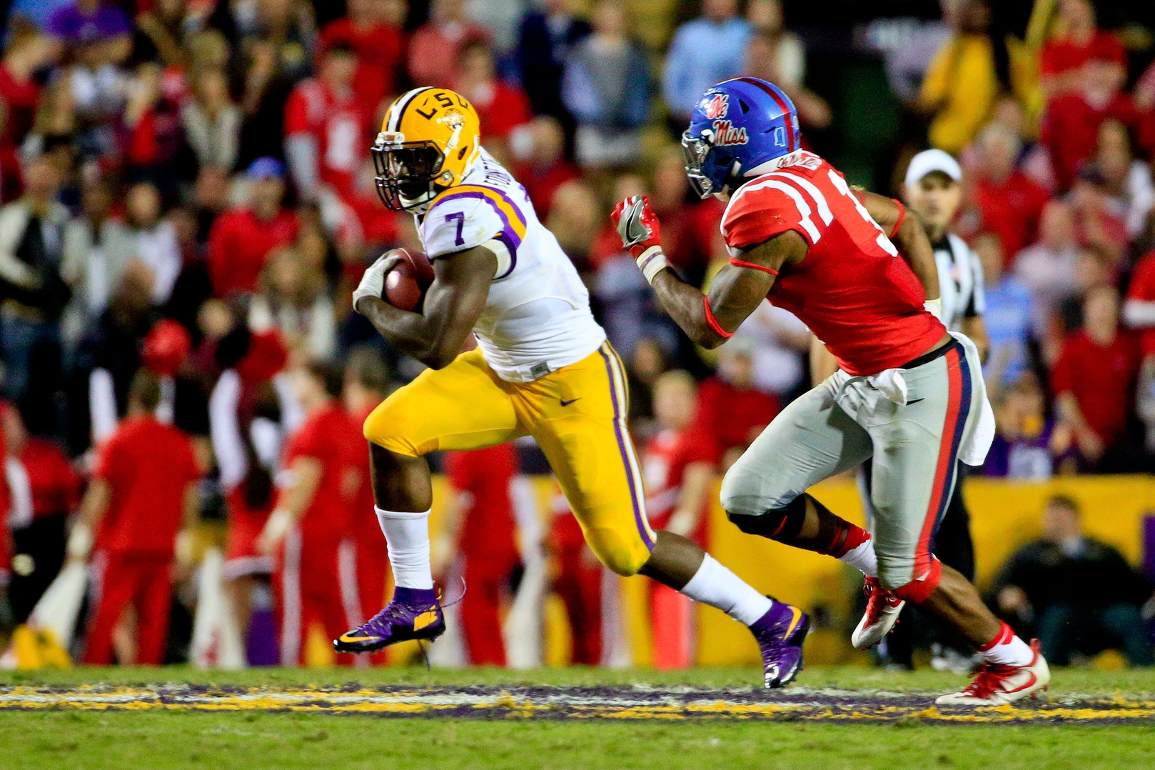 Oct 22, 2016; Baton Rouge, LA, USA; LSU Tigers running back Leonard Fournette (7) runs past Mississippi Rebels linebacker DeMarquis Gates (3) during the second half of a game at Tiger Stadium. LSU defeated Mississippi 38-21. Mandatory Credit: Derick E. Hingle-USA TODAY Sports
