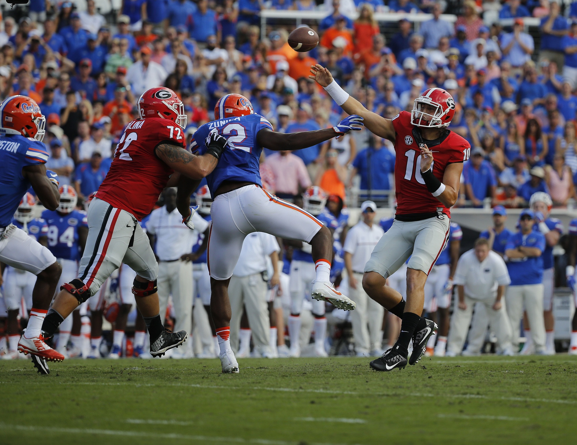 Oct 29, 2016; Jacksonville, FL, USA; Georgia Bulldogs quarterback Jacob Eason (10) throws the ball as Florida Gators defensive lineman Jabari Zuniga (92) pressures him during the first quarter at EverBank Field. Mandatory Credit: Kim Klement-USA TODAY Sports