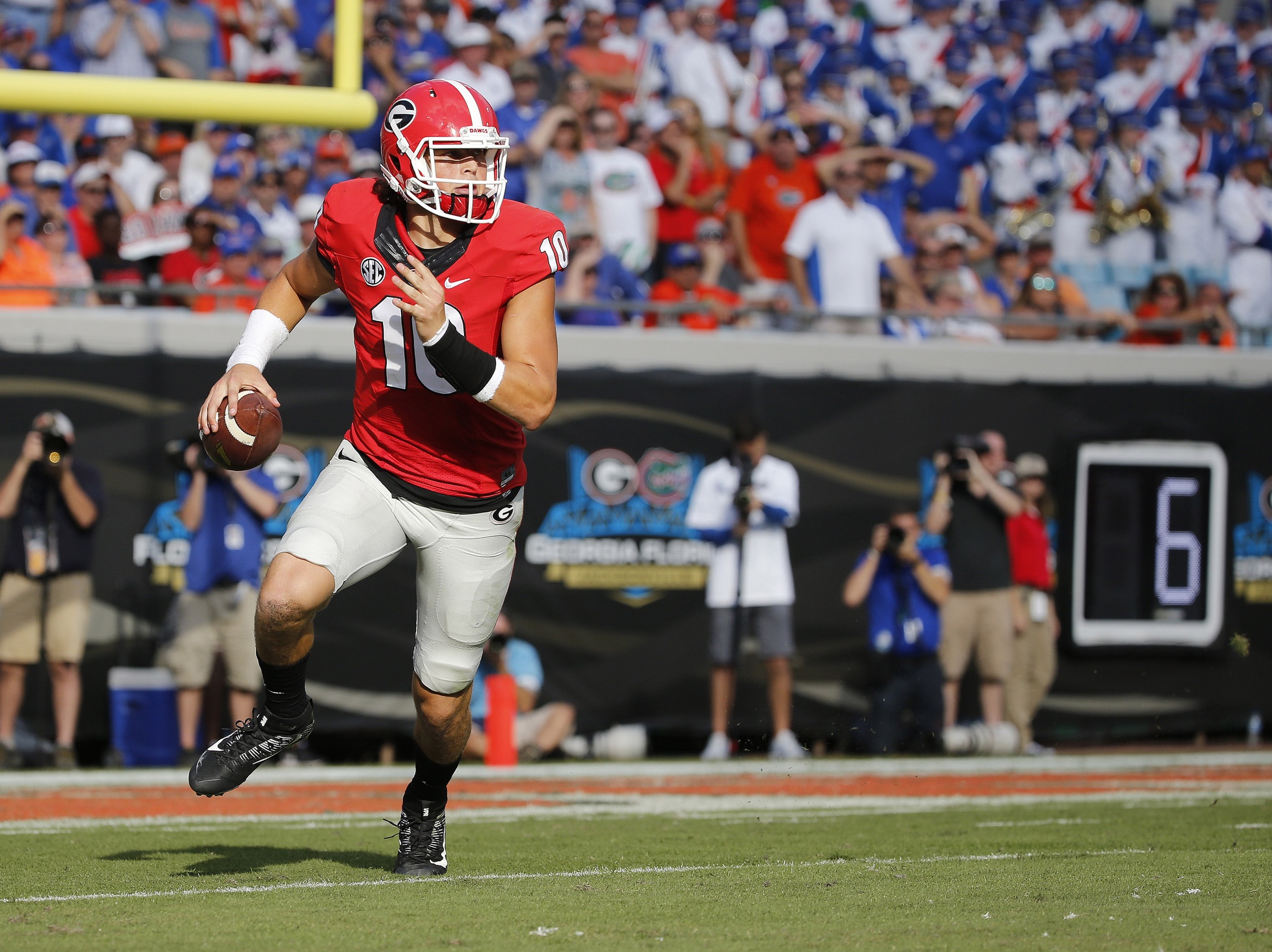 Oct 29, 2016; Jacksonville, FL, USA; Georgia Bulldogs quarterback Jacob Eason (10) runs out of the pocket against the Florida Gators during the first half at EverBank Field. Mandatory Credit: Kim Klement-USA TODAY Sports