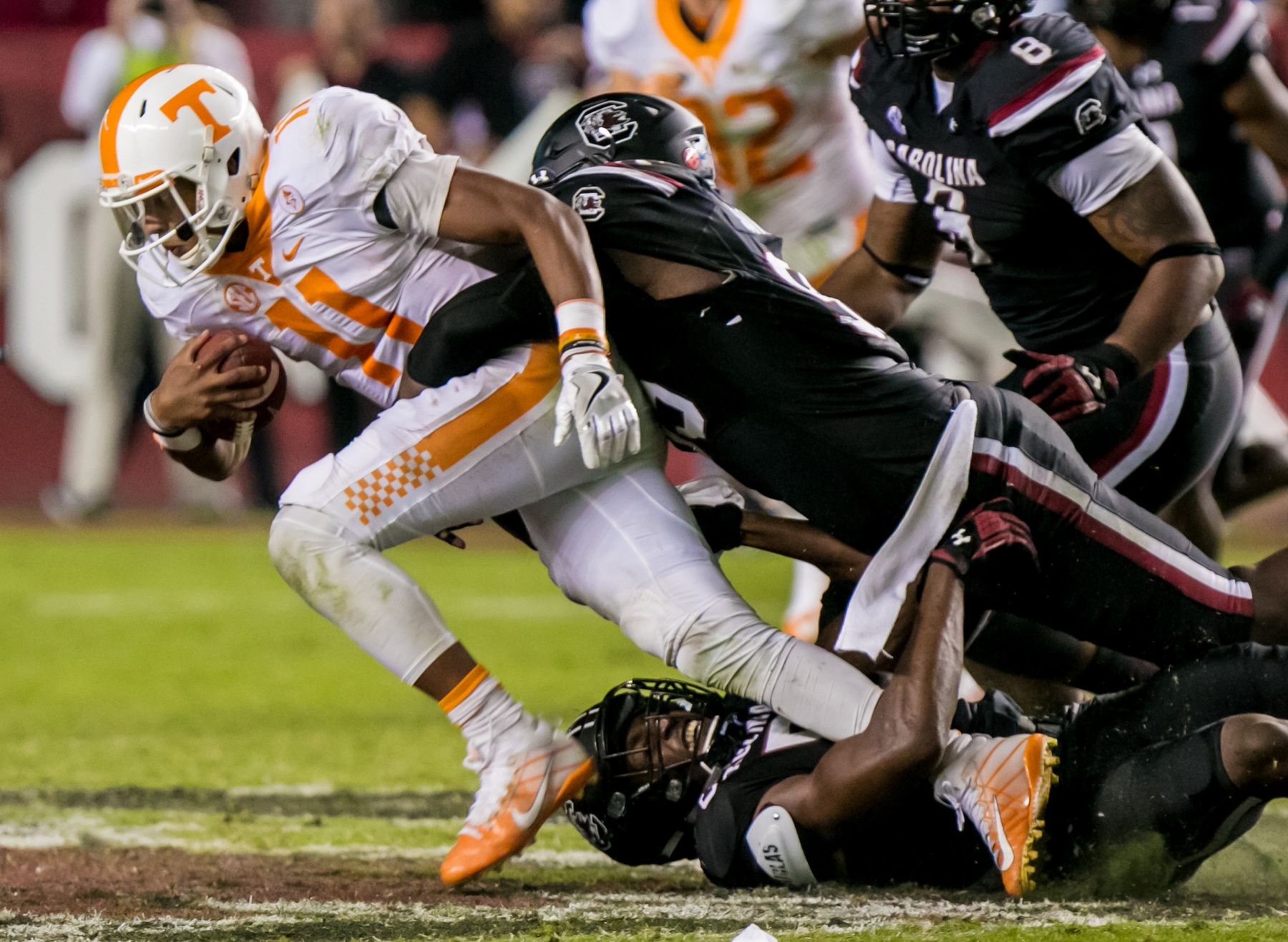 Oct 29, 2016; Columbia, SC, USA; Tennessee Volunteers quarterback Joshua Dobbs (11) is brought down by South Carolina Gamecocks defensive lineman Darius English (5) and South Carolina Gamecocks defensive lineman Dante Sawyer (95) in the second half at Williams-Brice Stadium. Mandatory Credit: Jeff Blake-USA TODAY Sports