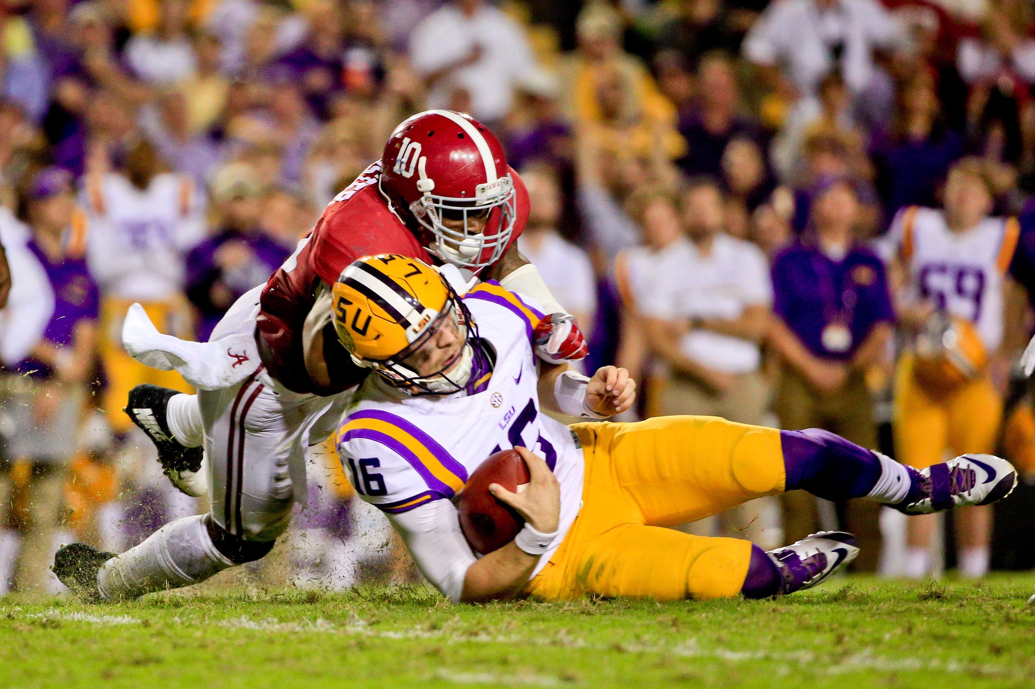 Nov 5, 2016; Baton Rouge, LA, USA; LSU Tigers quarterback Danny Etling (16) is hit by Alabama Crimson Tide linebacker Reuben Foster (10) as he slides during the second quarter of a game at Tiger Stadium. Mandatory Credit: Derick E. Hingle-USA TODAY Sports