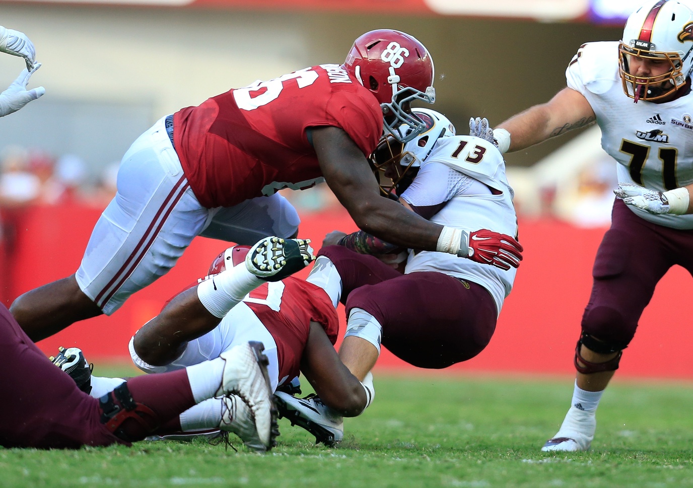 Sep 26, 2015; Tuscaloosa, AL, USA; Alabama Crimson Tide defensive lineman A'Shawn Robinson (86) tackles Louisiana Monroe Warhawks quarterback Garrett Smith (13) at Bryant-Denny Stadium. The Tide defeated the Warhawks 34-0. Mandatory Credit: Marvin Gentry-USA TODAY Sports