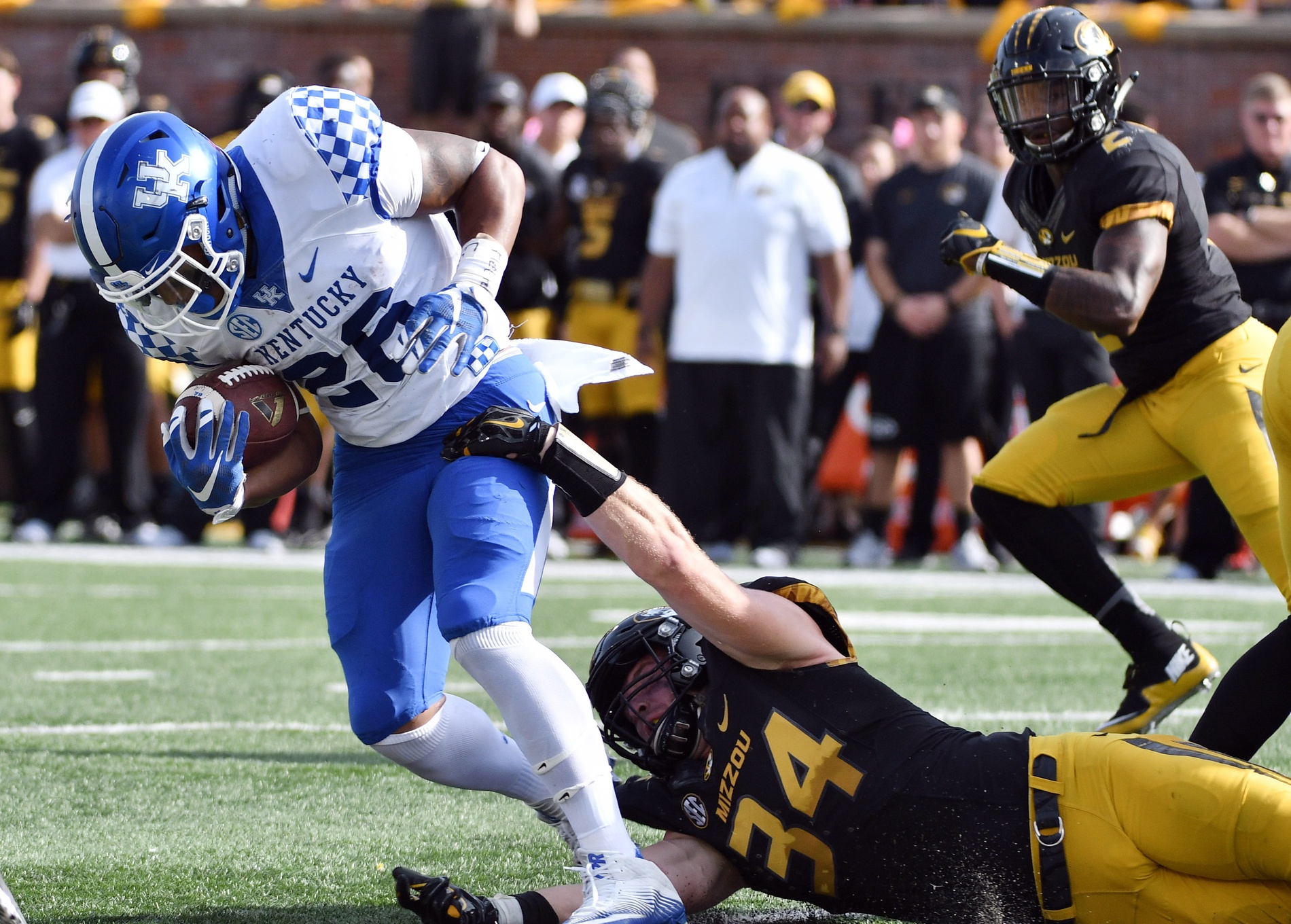 Oct 29, 2016; Columbia, MO, USA; Kentucky Wildcats running back Benjamin Snell Jr. (26) runs the ball as Missouri Tigers linebacker Joey Burkett (34) makes the tackle during the first half at Faurot Field. Mandatory Credit: Denny Medley-USA TODAY Sports