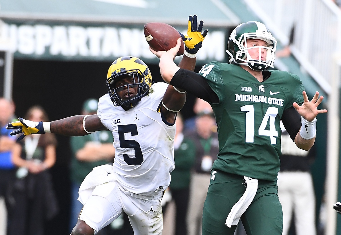 Oct 29, 2016; East Lansing, MI, USA; Michigan State Spartans quarterback Brian Lewerke (14) attempts a pass as Michigan Wolverines linebacker Jabrill Peppers (5) defends during the second half at Spartan Stadium. Mandatory Credit: Brad Mills-USA TODAY Sports