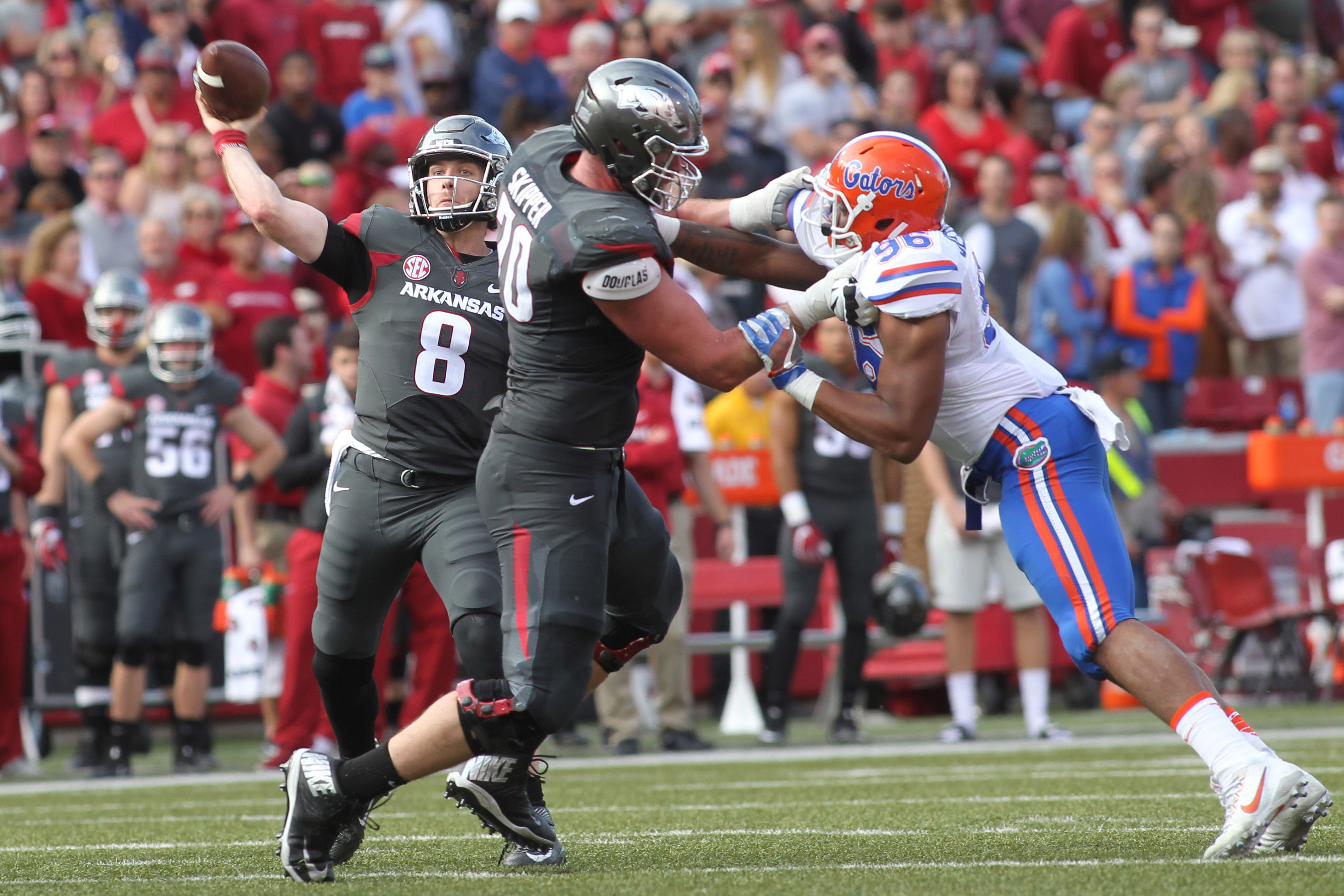 Nov 5, 2016; Fayetteville, AR, USA; Arkansas Razorbacks quarterback Austin Allen (8) passes behind a block by offensive lineman Dan Skipper (70) on Florida Gators defensive lineman Cece Jefferson (96) at Donald W. Reynolds Razorback Stadium. Mandatory Credit: Nelson Chenault-USA TODAY Sports