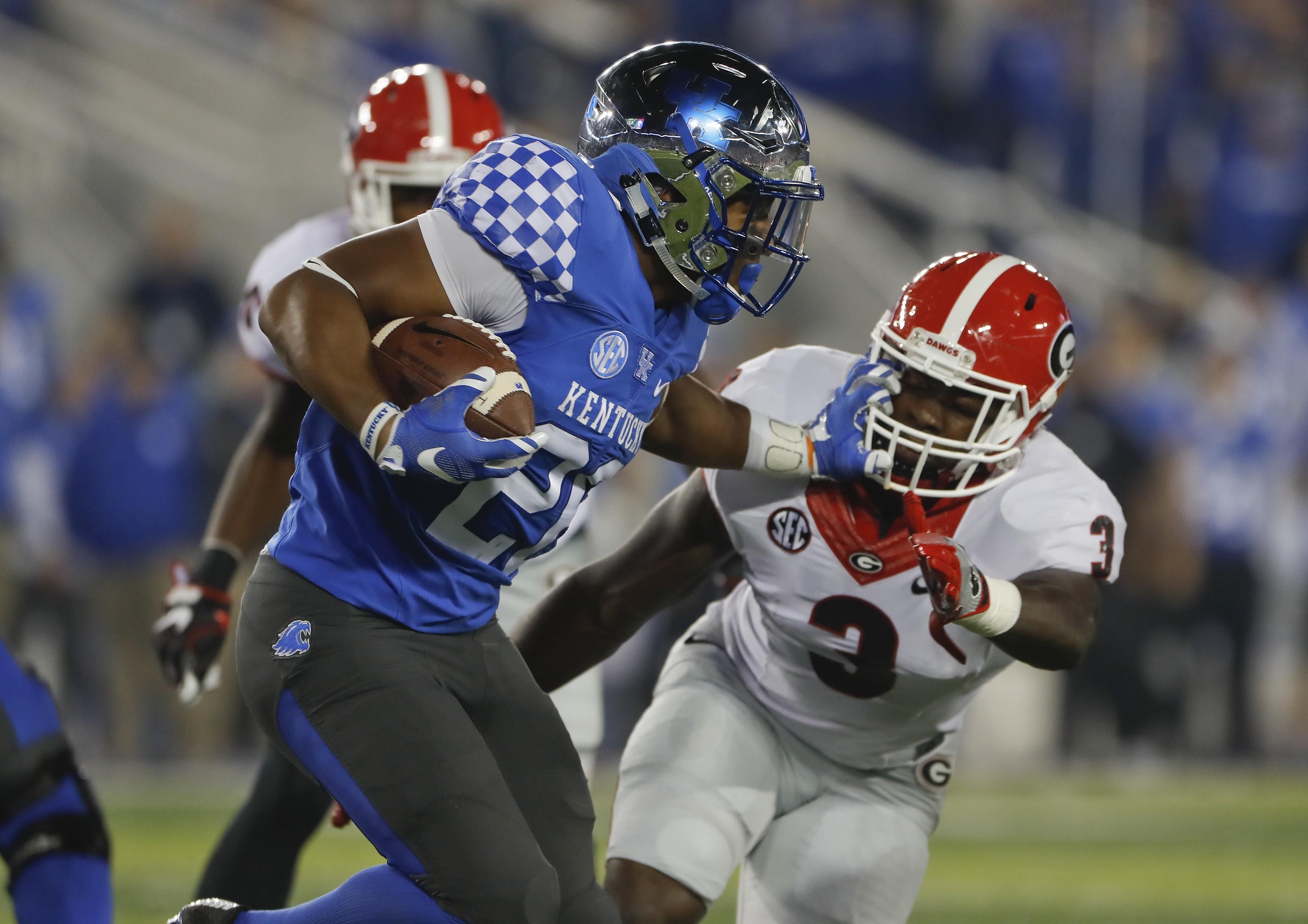 Nov 5, 2016; Lexington, KY, USA; Kentucky Wildcats running back Benny Snell (26) runs the ball against Georgia Bulldogs linebacker Roquan Smith (3) in the first quarter at Commonwealth Stadium. Mandatory Credit: Mark Zerof-USA TODAY Sports