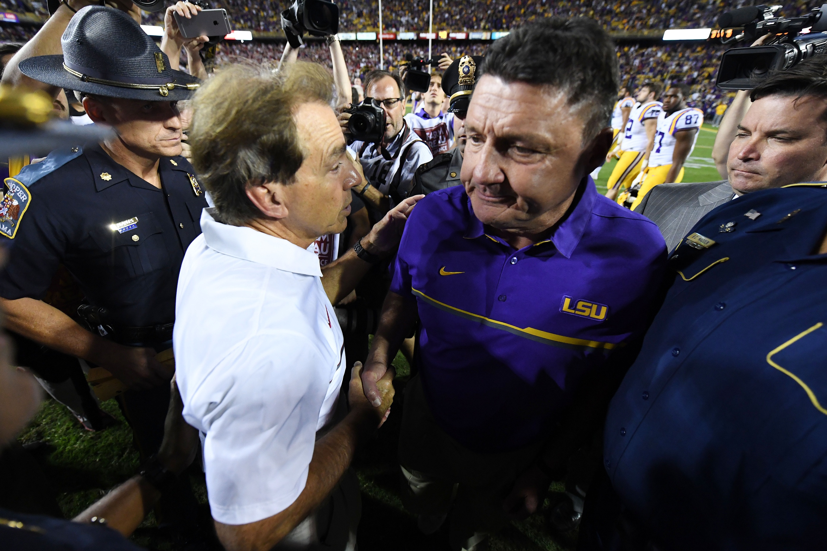 Nov 5, 2016; Baton Rouge, LA, USA; Alabama Crimson Tide head coach Nick Saban greets LSU Tigers head coach Ed Orgeron following the Tides 10-0 win over the LSU Tigers at Tiger Stadium. Mandatory Credit: John David Mercer-USA TODAY Sports