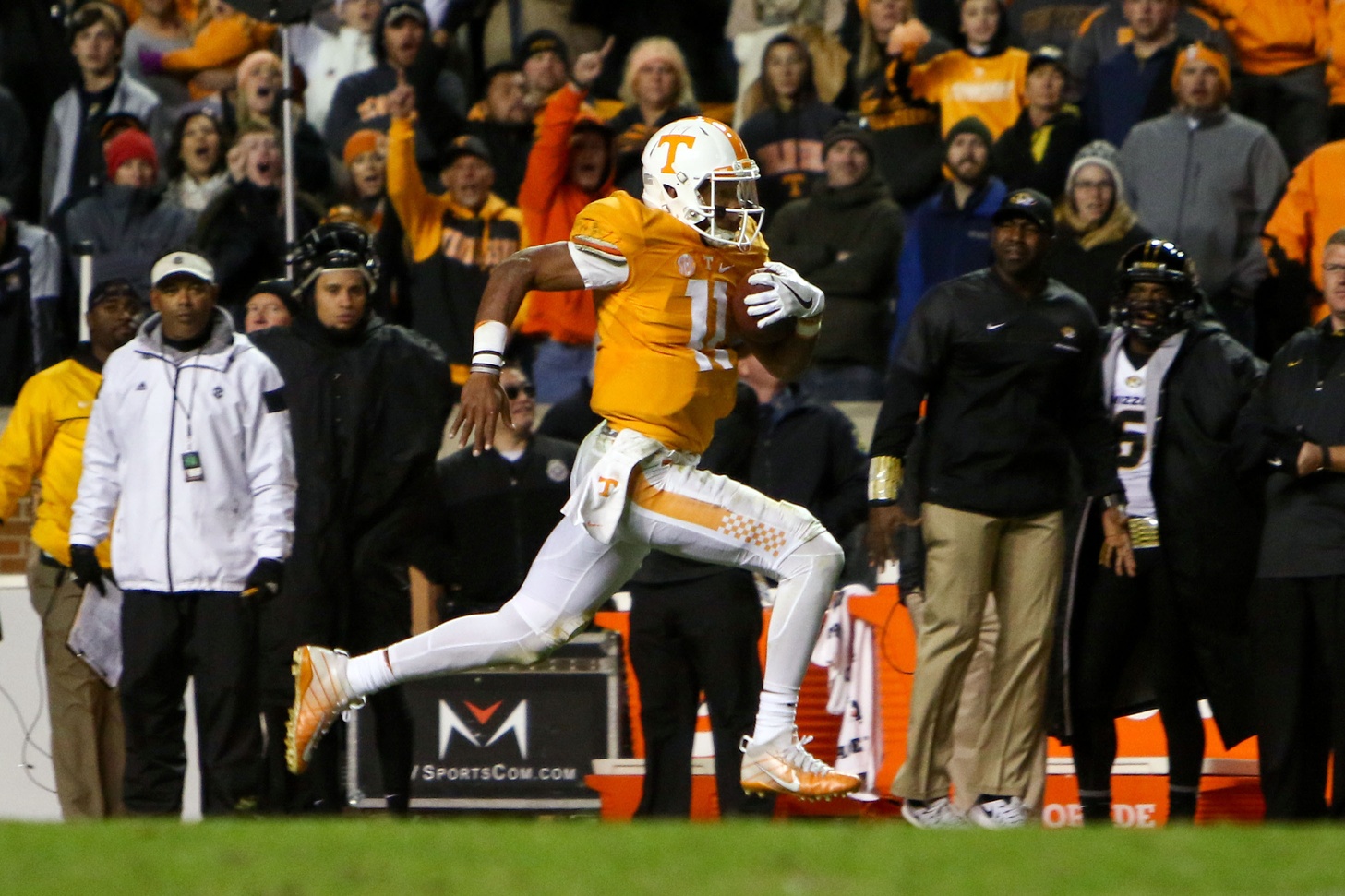 Nov 19, 2016; Knoxville, TN, USA; Tennessee Volunteers quarterback Joshua Dobbs (11) runs for a touchdown against the Missouri Tigers during the second half at Neyland Stadium. Tennessee won 63 to 37. Mandatory Credit: Randy Sartin-USA TODAY Sports