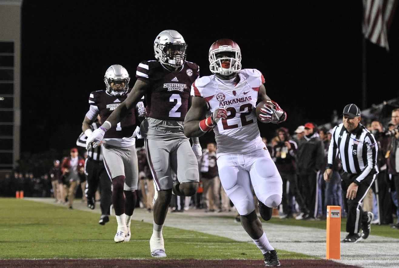 Nov 19, 2016; Starkville, MS, USA; Arkansas Razorbacks running back Rawleigh Williams III (22) scores a touchdown against Mississippi State Bulldogs defensive back Jamal Peters (2) during the first half at Davis Wade Stadium. Mandatory Credit: Justin Ford-USA TODAY Sports