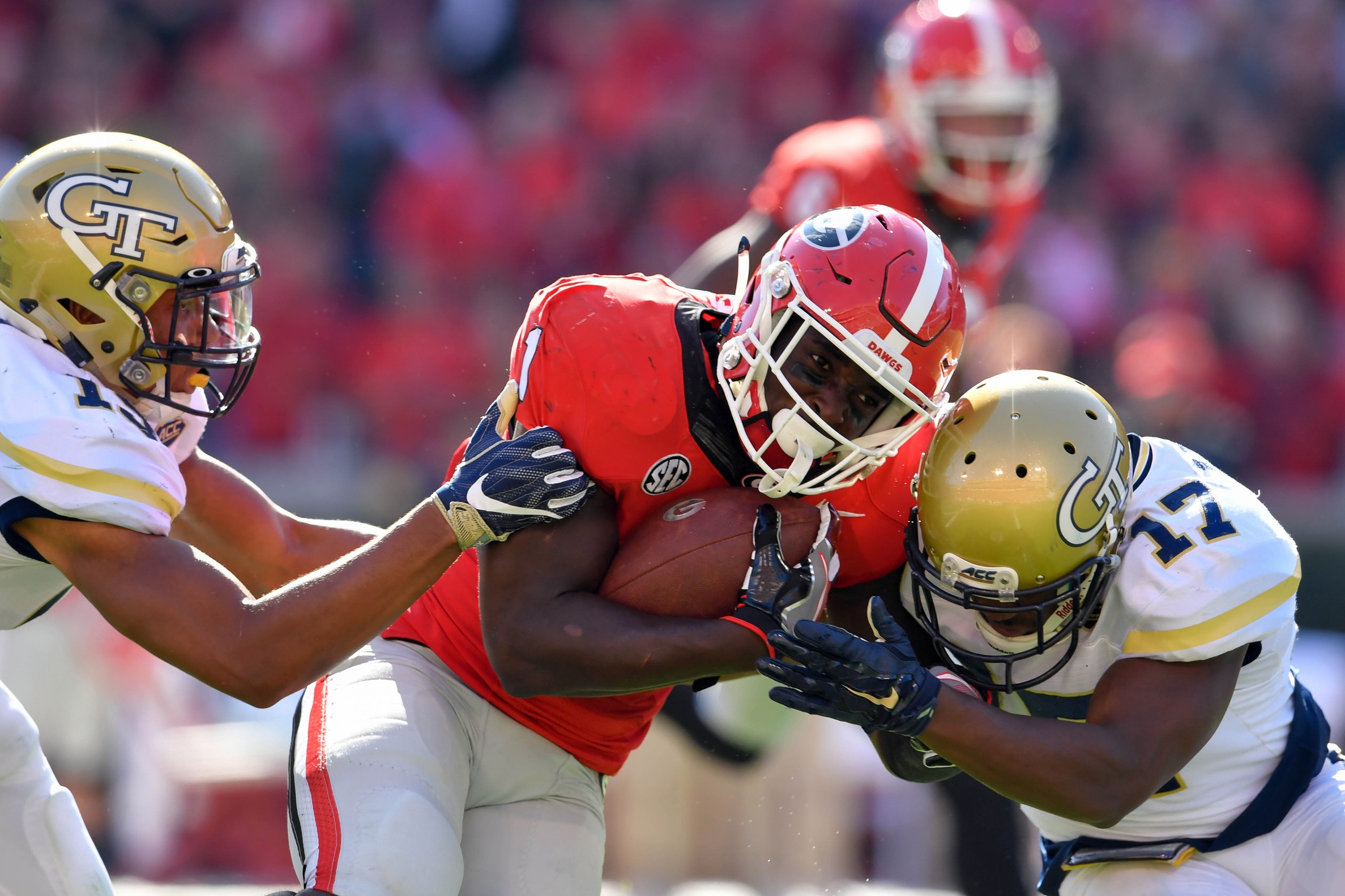 Nov 26, 2016; Athens, GA, USA; Georgia Bulldogs running back Sony Michel (1) is tackled by Georgia Tech Yellow Jackets defensive back A.J. Gray (15) and defensive back Lance Austin (17) after a long run during the second quarter at Sanford Stadium. Mandatory Credit: Dale Zanine-USA TODAY Sports