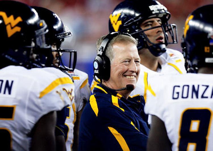Dec 28, 2010; Orlando, FL, USA; West Virginia Mountaineers head coach Bill Stewart watches play against the North Carolina State Wolfpack during the third quarter of the 2010 Champs Sports Bowl at the Citrus Bowl. North Carolina State defeated West Virginia 23-7. Mandatory Credit: Douglas Jones-USA TODAY Sports