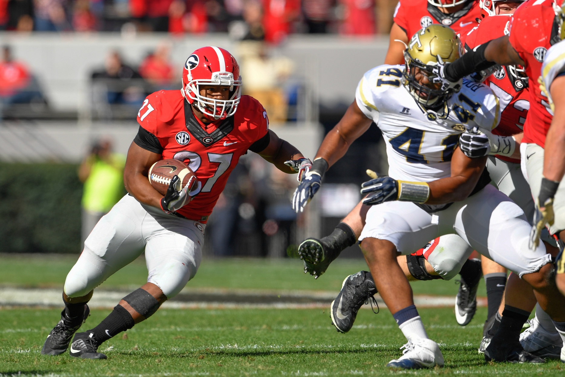 Nov 26, 2016; Athens, GA, USA; Georgia Bulldogs running back Nick Chubb (27) runs against Georgia Tech Yellow Jackets defensive end Rod Rook-Chungong (41) during the first half at Sanford Stadium. Georgia Tech defeated Georgia 28-27. Mandatory Credit: Dale Zanine-USA TODAY Sports