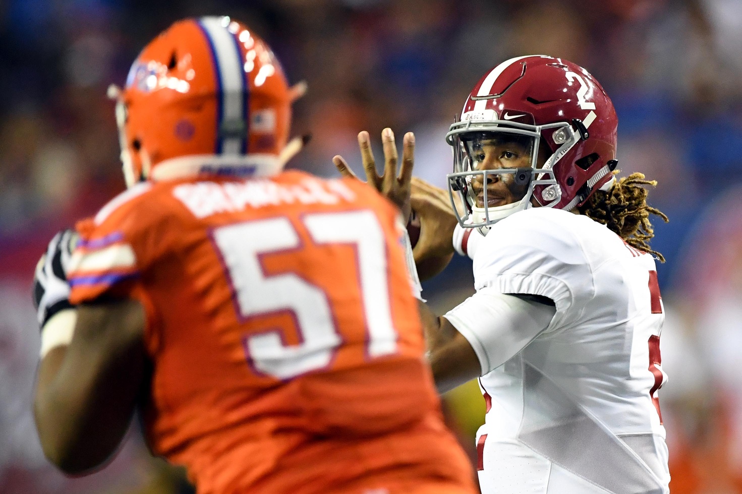 Dec 3, 2016; Atlanta, GA, USA; Alabama Crimson Tide quarterback Jalen Hurts (2) looks to pass while defended by Florida Gators defensive lineman Caleb Brantley (57) during the second quarter of the SEC Championship college football game at Georgia Dome. Mandatory Credit: John David Mercer-USA TODAY Sports