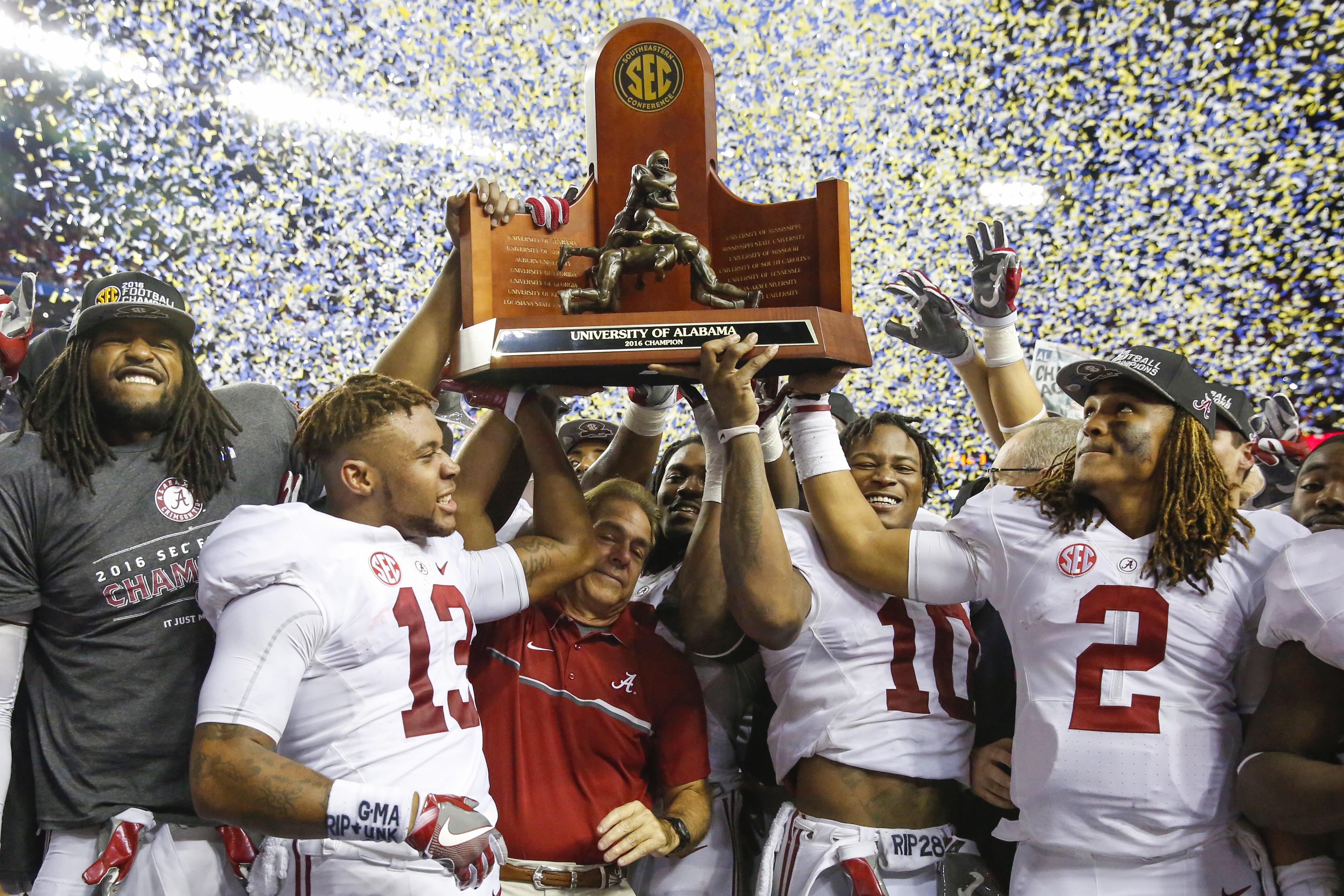 Dec 3, 2016; Atlanta, GA, USA; Alabama Crimson Tide head coach Nick Saban celebrates winning the trophy with his team after the SEC Championship college football game against the Florida Gators at Georgia Dome. Alabama defeated Florida 54-16. Mandatory Credit: Jason Getz-USA TODAY Sports