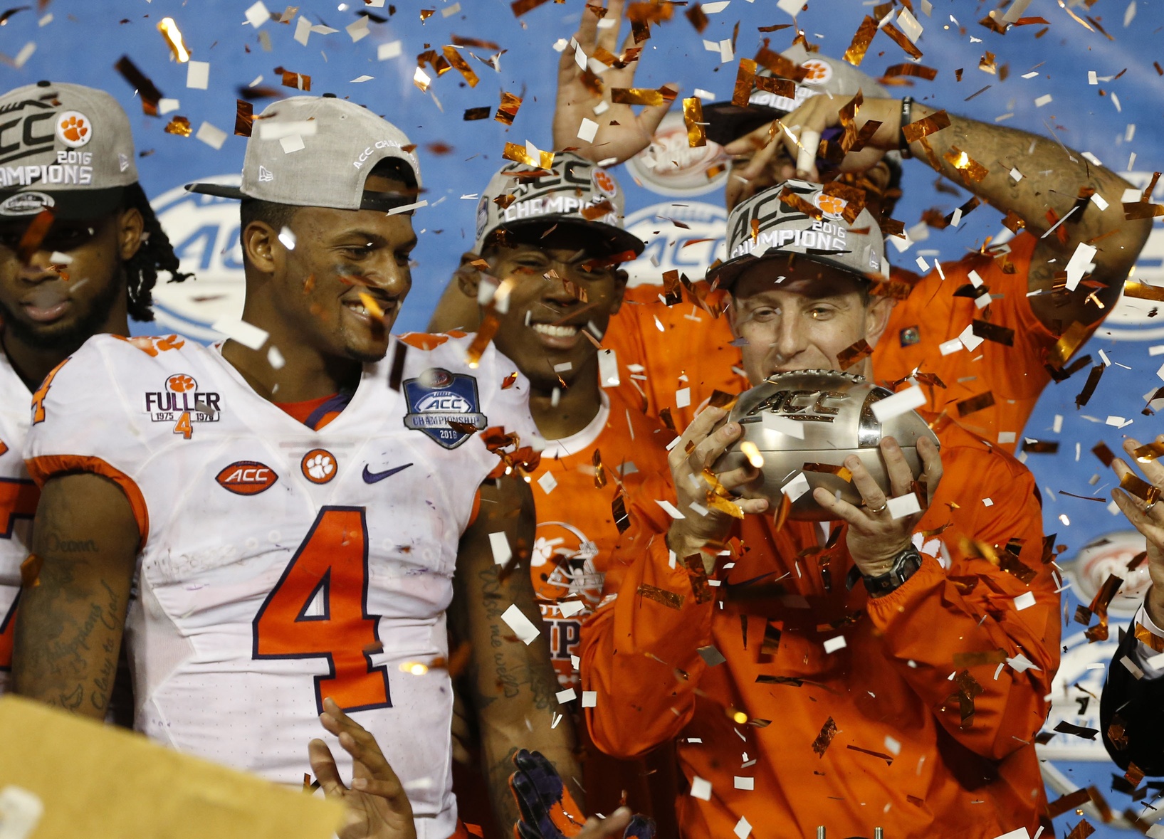 Dec 3, 2016; Orlando, FL, USA; Clemson Tigers head coach Dabo Swinney and quarterback Deshaun Watson (4) and teammates celebrate as they won the ACC Championship college football game against the Virginia Tech Hokies at Camping World Stadium. Clemson Tigers defeated the Virginia Tech Hokies 42-35. Mandatory Credit: Kim Klement-USA TODAY Sports