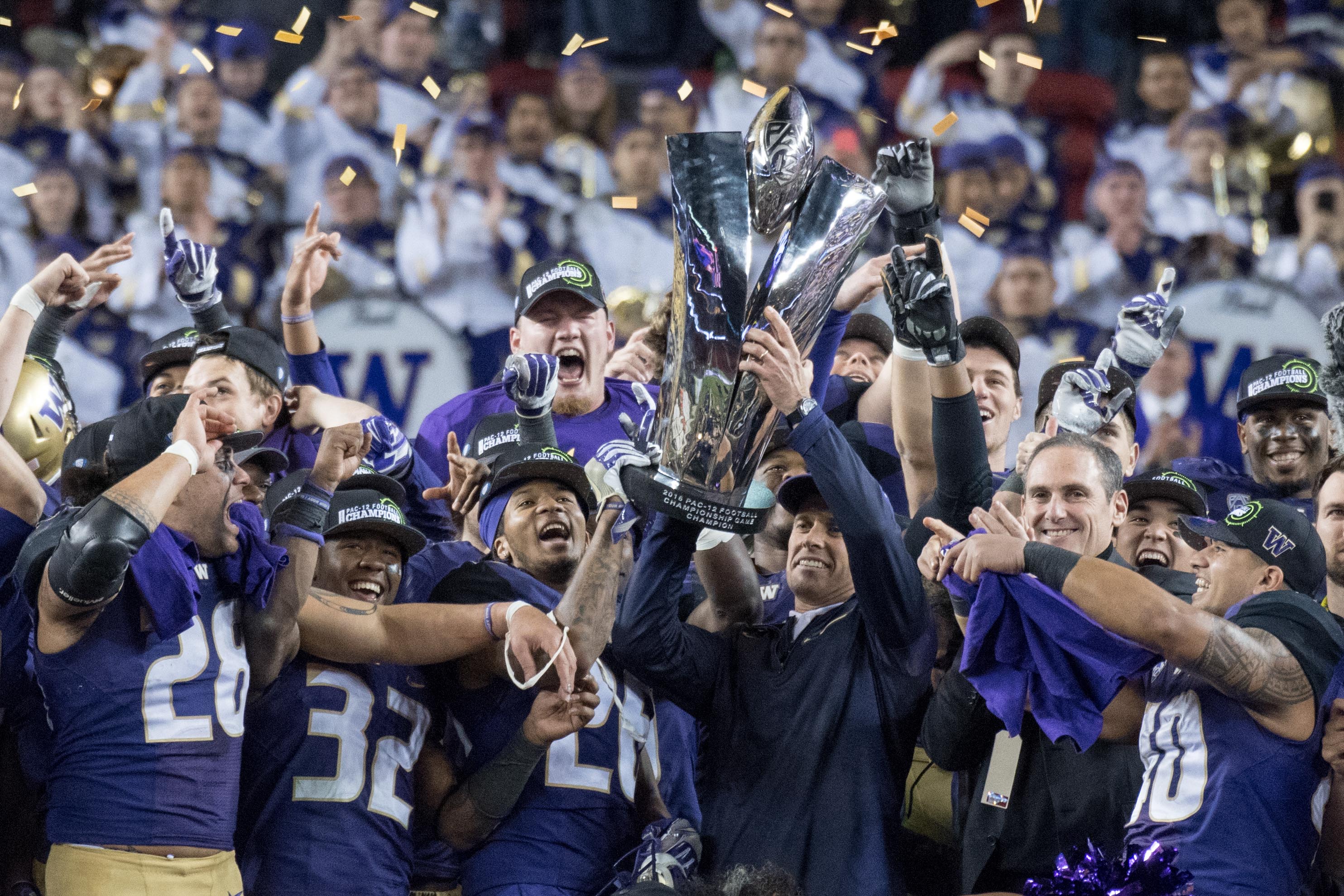 December 2, 2016; Santa Clara, CA, USA; Washington Huskies head coach Chris Petersen hoists the championship trophy after the Pac-12 championship against the Colorado Buffaloes at Levi's Stadium. The Huskies defeated the Buffaloes 41-10. Mandatory Credit: Kyle Terada-USA TODAY Sports