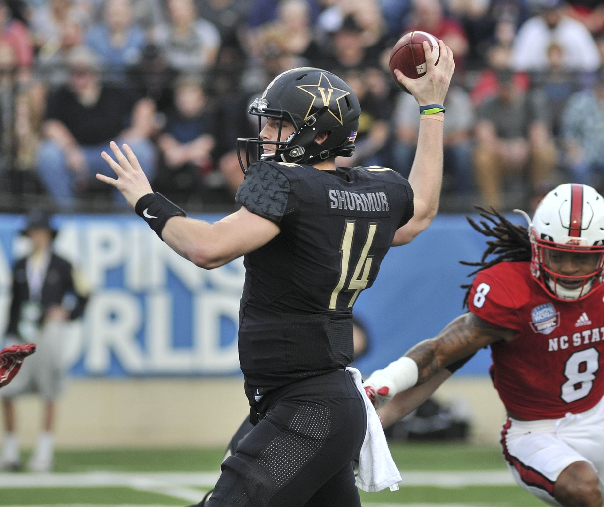 Dec 26, 2016; Shreveport, LA, USA; Vanderbilt Commodores quarterback Kyle Shurmur (14) attempts to pass the ball while being pressured by North Carolina State Wolfpack defensive back Dravious Wright (8) during the first halfi at Independence Stadium. Mandatory Credit: Justin Ford-USA TODAY Sports