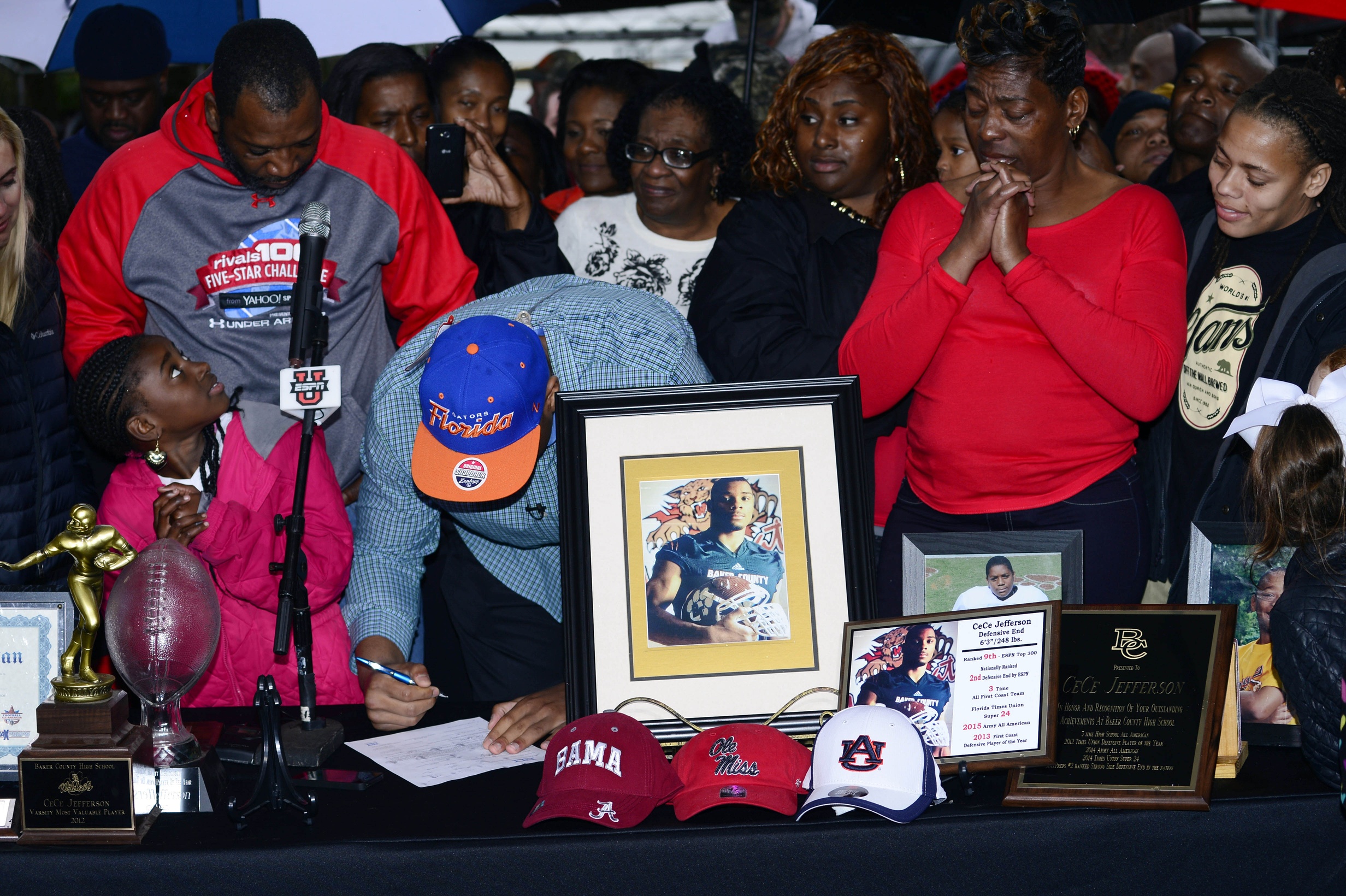 Feb 4, 2015; Glen Saint Mary, FL, USA; Ce Ce Jefferson signs with the University of Florida at his home near Baker County High School as his parents Leo and Annette Jefferson look on. Mandatory Credit: Richard Dole-USA TODAY Sports