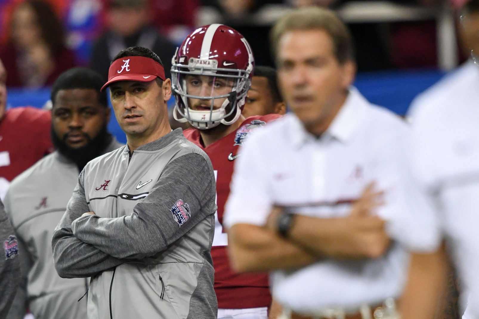 Dec 31, 2016; Atlanta, GA, USA; Alabama Crimson Tide incoming offensive coordinator Steve Sarkisian looks on during warm-ups as Alabama Crimson Tide head coach Nick Saban coaches in the foreground prior to the 2016 CFP Semifinal against the Washington Huskies at the Georgia Dome. Mandatory Credit: RVR Photos-USA TODAY Sports